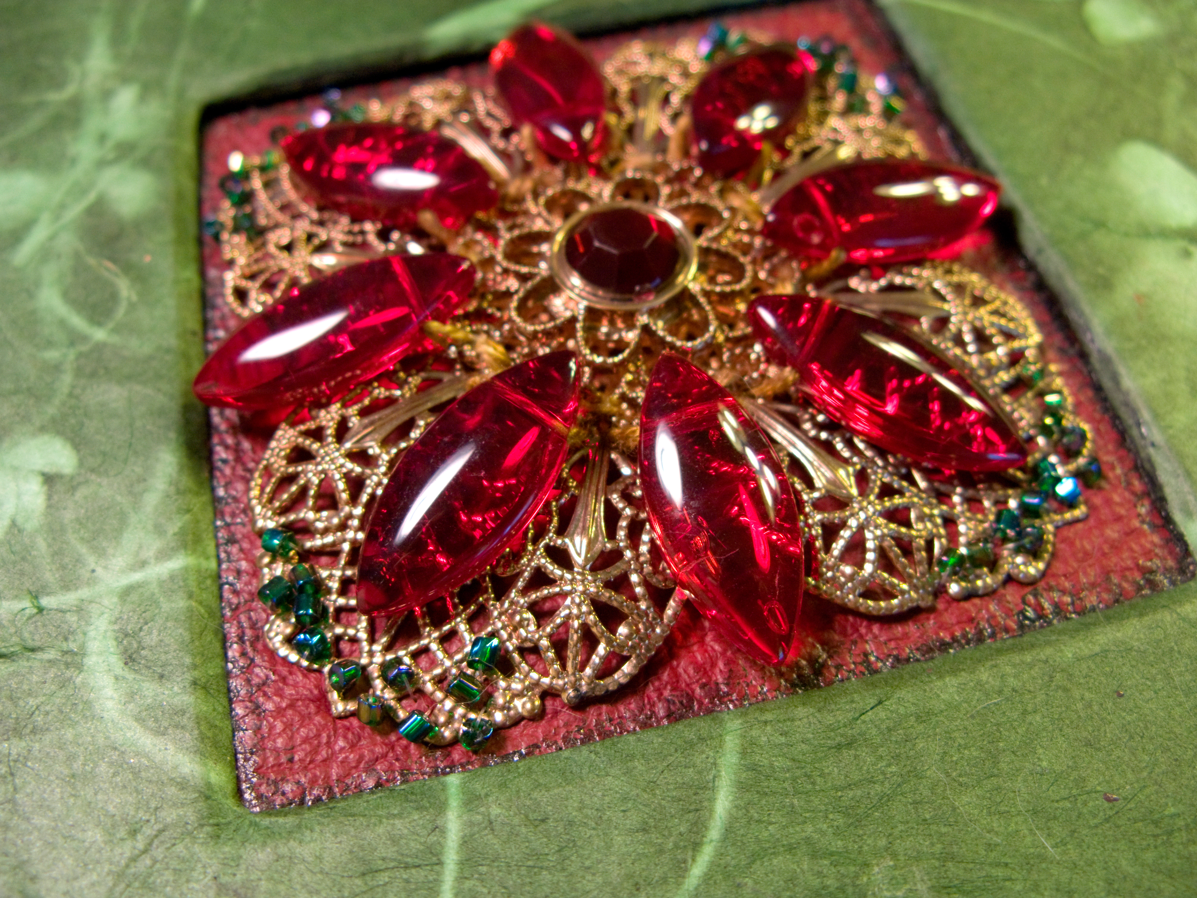 Originally, as seen here, I used floss on the teardrop beads. It was fun and jingly, but sketchbooks get abused and it eventually brook. I replaced with wire as I should have (more easily) done from the beginning.