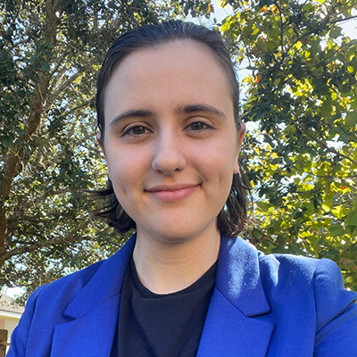 Image of A. Dickens wearing a royal blue blazer