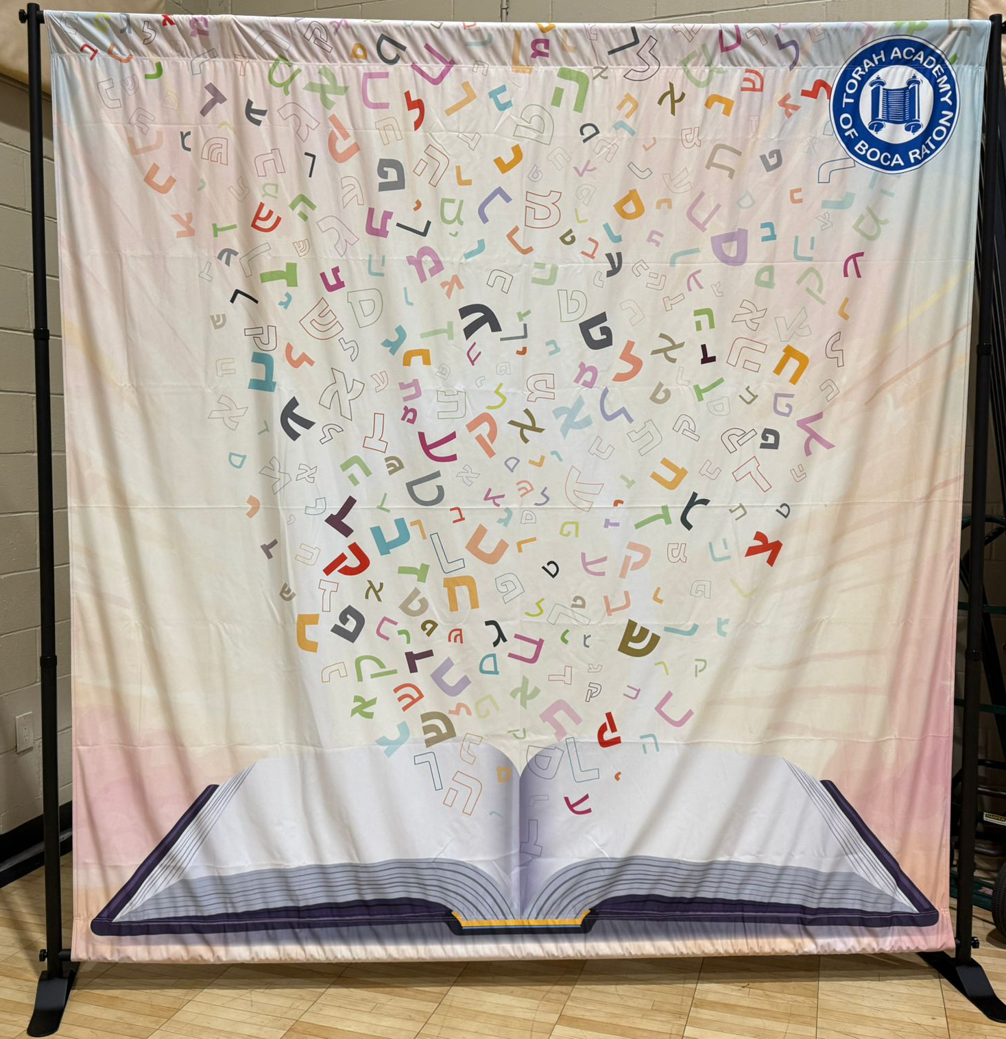 Photo op with siddur open and the alef beis going up to the heavens in prayer