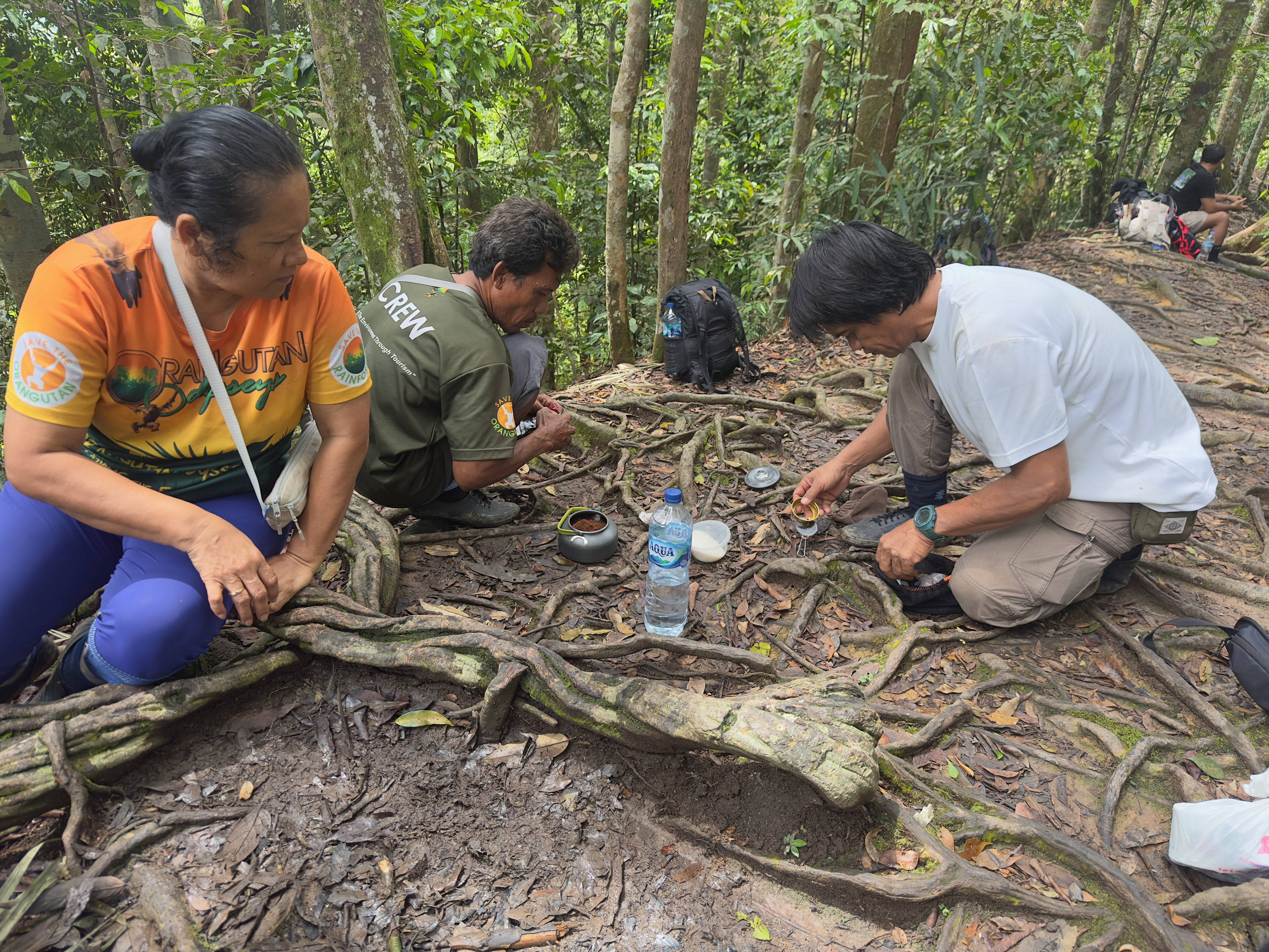 Lucy, Sabah, and Rahman prepping coffee.