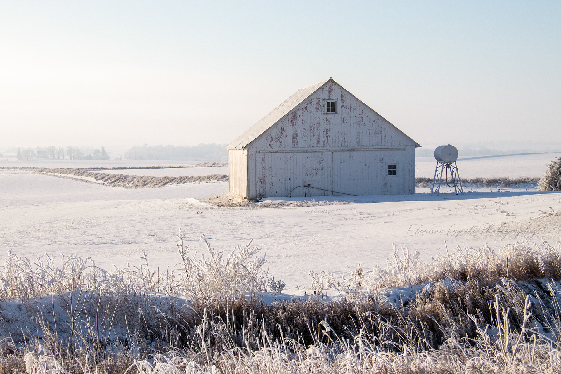 White Barn in snow with water tank hwy 30 south