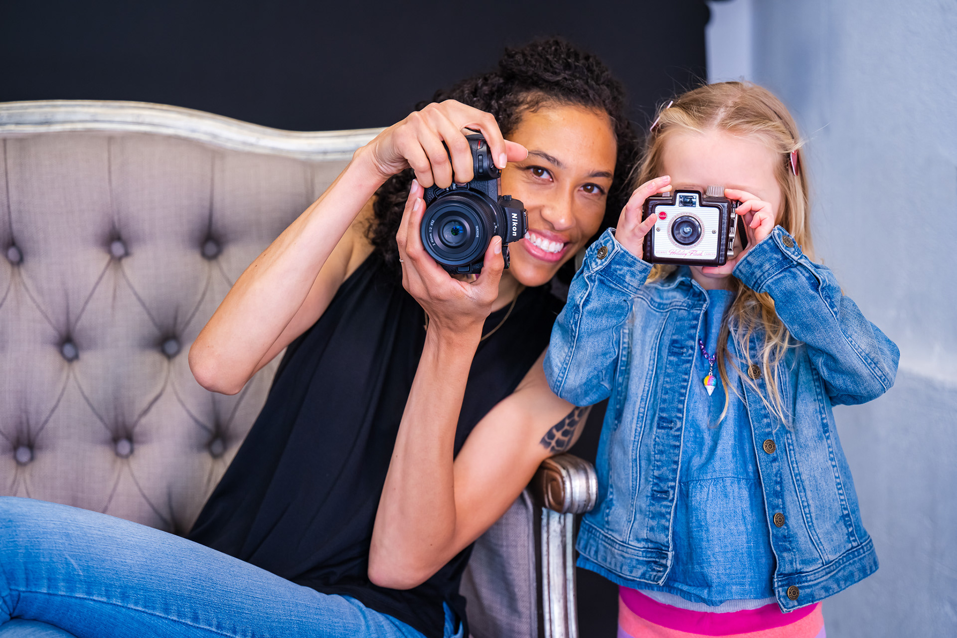 Kaitlyn and a tiny client, posing with their cameras at a session.
