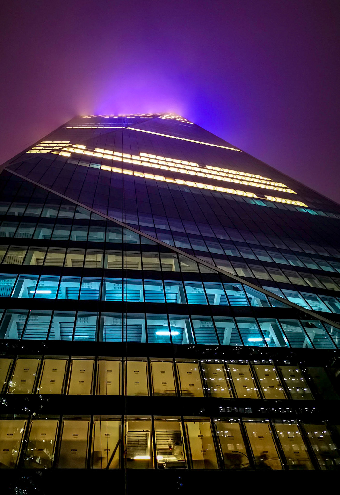 Another one shot on the way home on my phone.  Over the past year I've watched this building slowly being completed and on this night there were some low clouds causing the blue and red lights on the top to mix causing this strange purple glow.