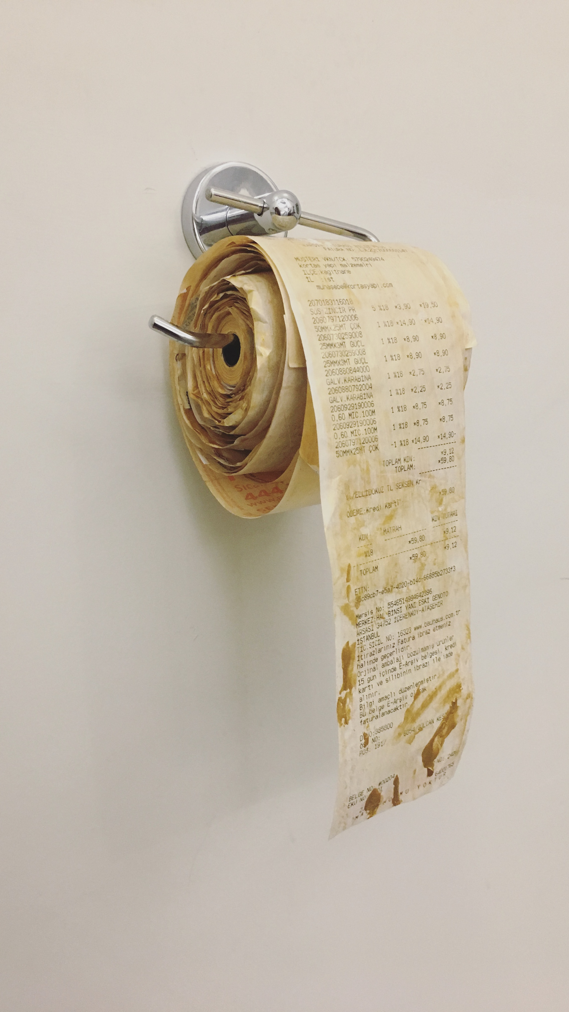 BilToilet Paper, 2017, Changeable Size, toilet paper holder, bills, Independent Art Foundation Art Gallery, Istanbul. Photo: Tuğba Renkçi Taştan
