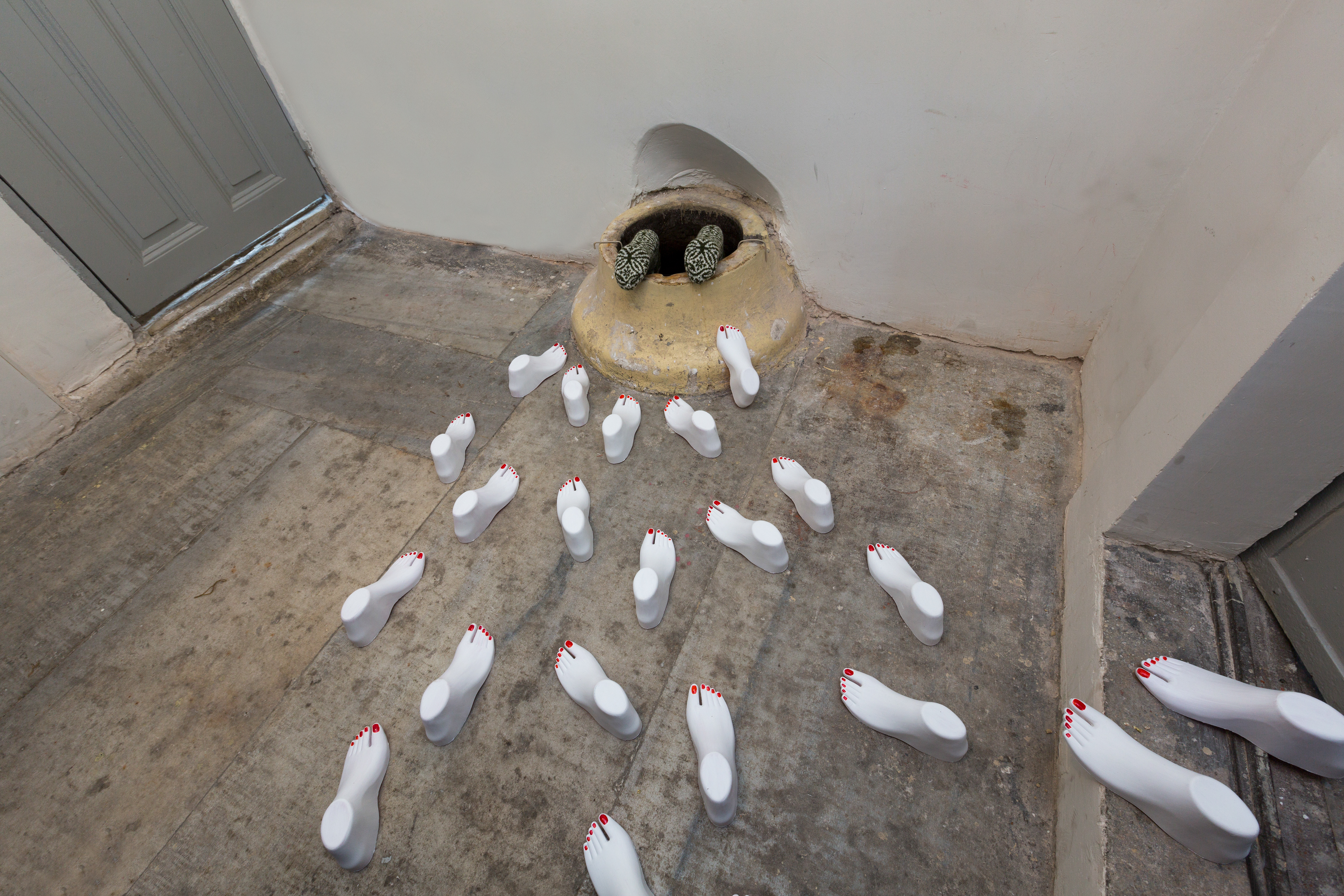 Well On The Edge, 2017, Changeable Size, feet, well, wool socks, Independent Art Foundation Art Gallery, Istanbul. Photo: İsmail Coşkun.