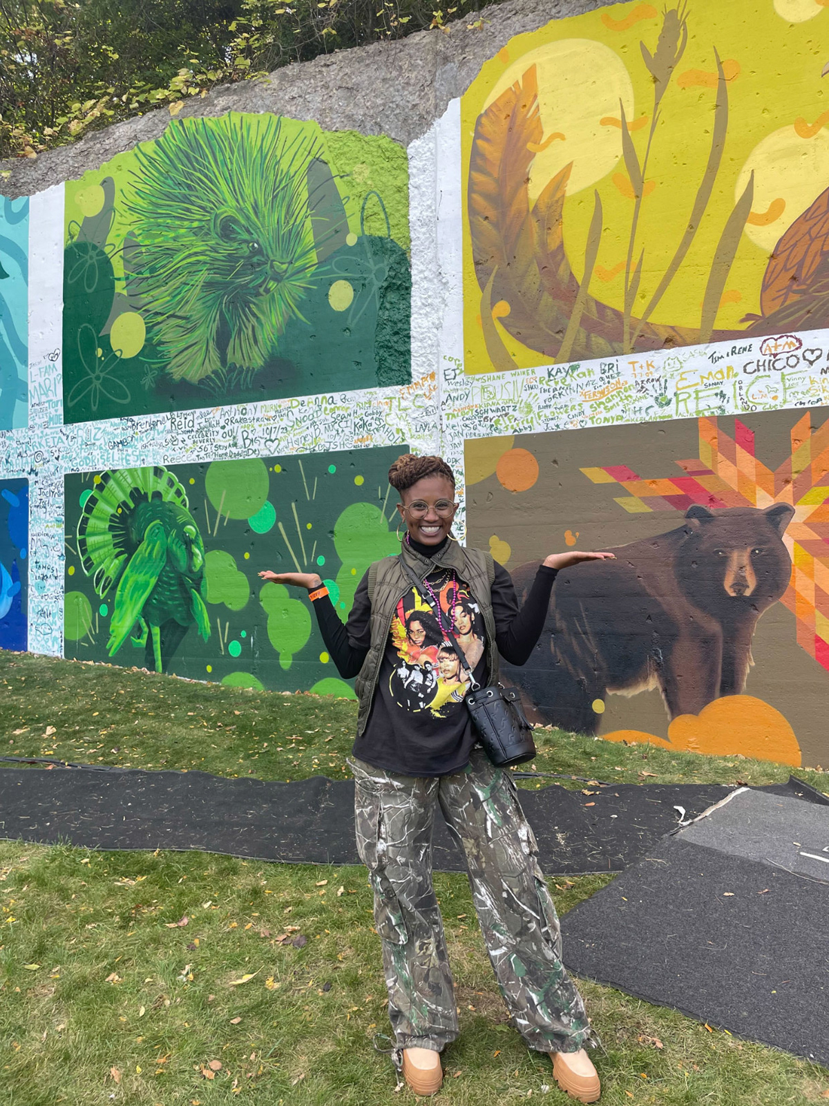 Actor for the campaign posing with the mural — part of a Detroit Harvest Fest activation effort