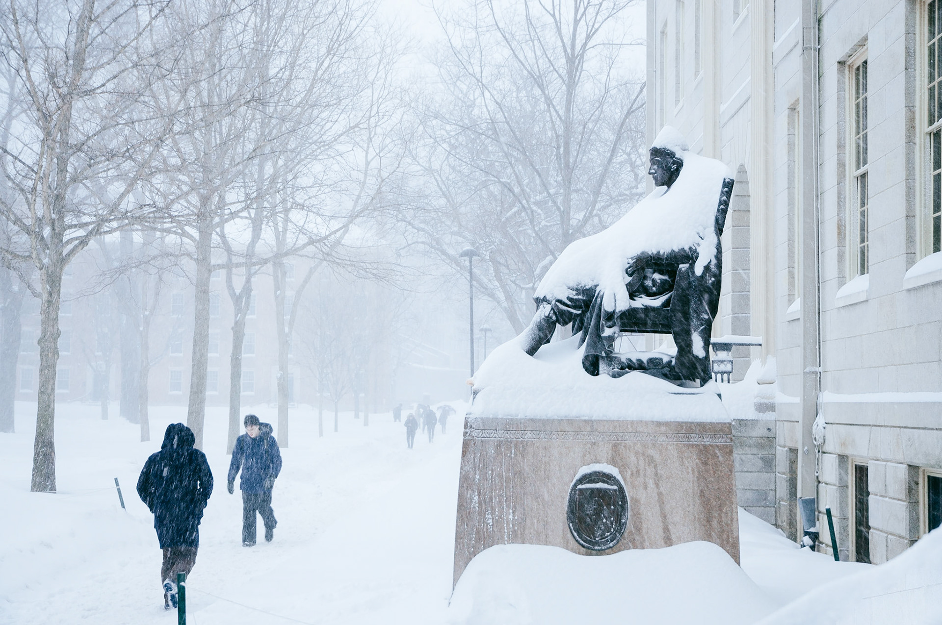 John Harvard statue during winter snowstorm. Photo taken by Dean Shu.
