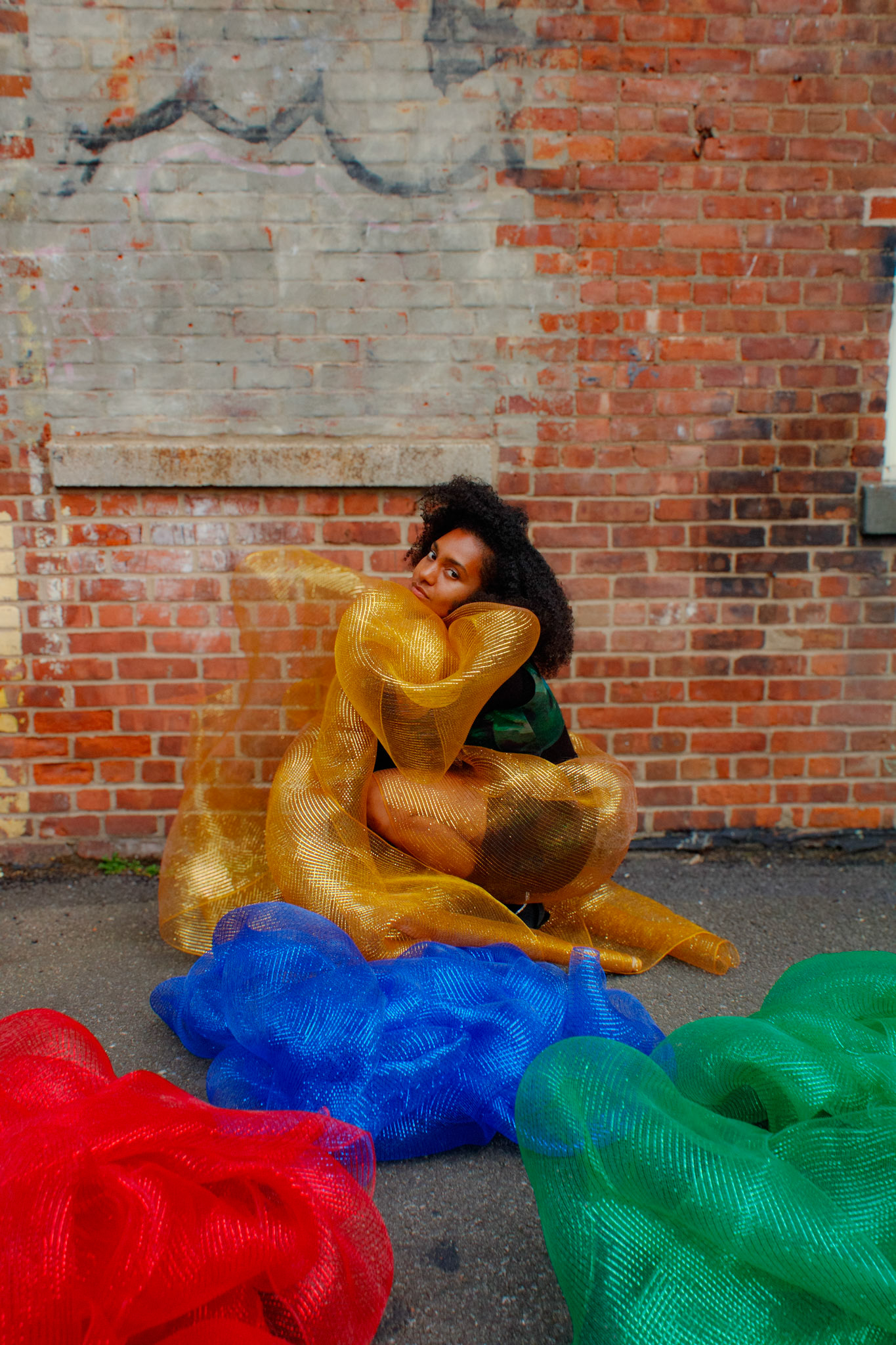 'Mesh' Workshop participant chooses gold mesh to wrap herself in with photo exercise.