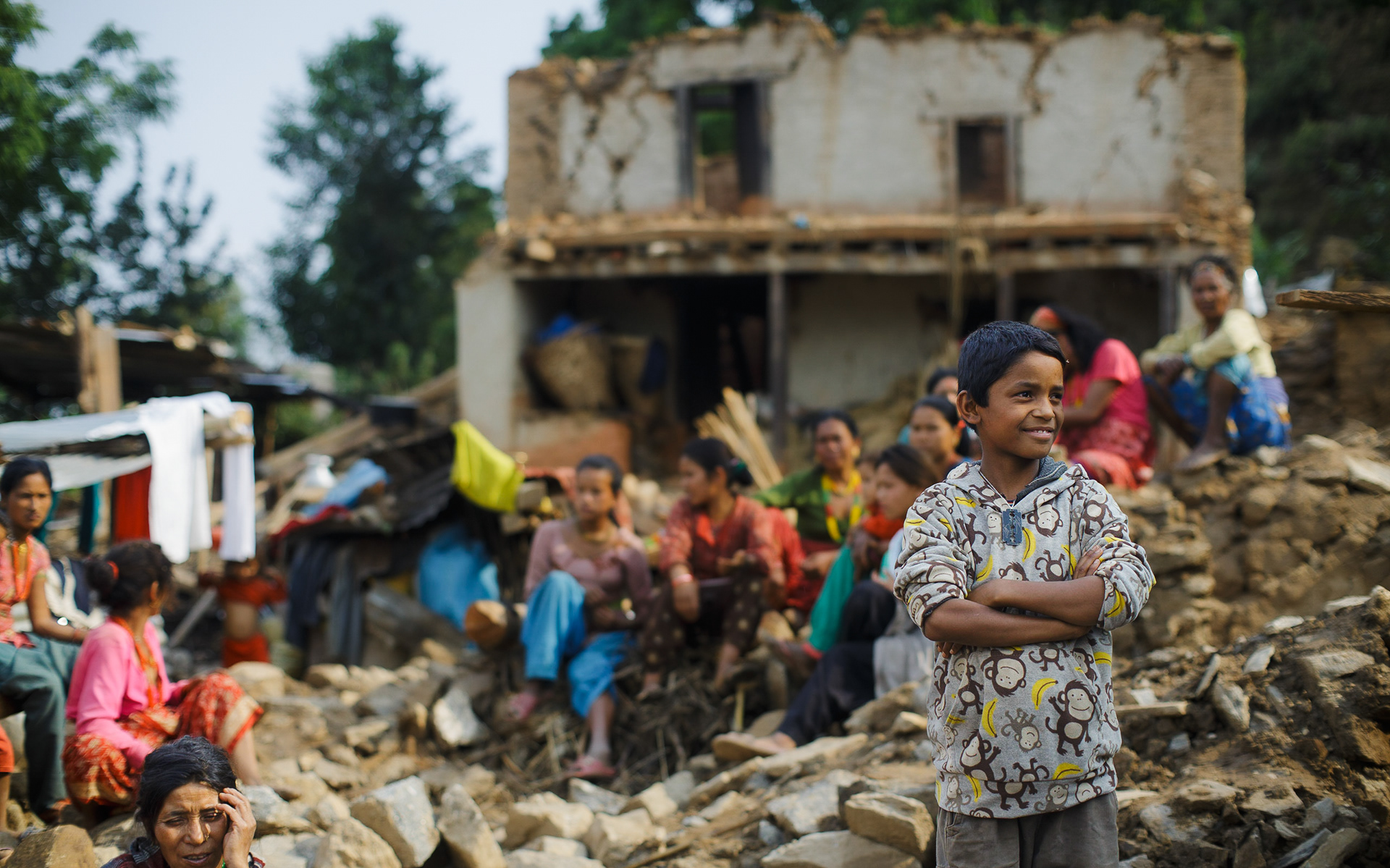 Child in front of rubbles from collapsed houses due to an earthquake, Nepal 2015