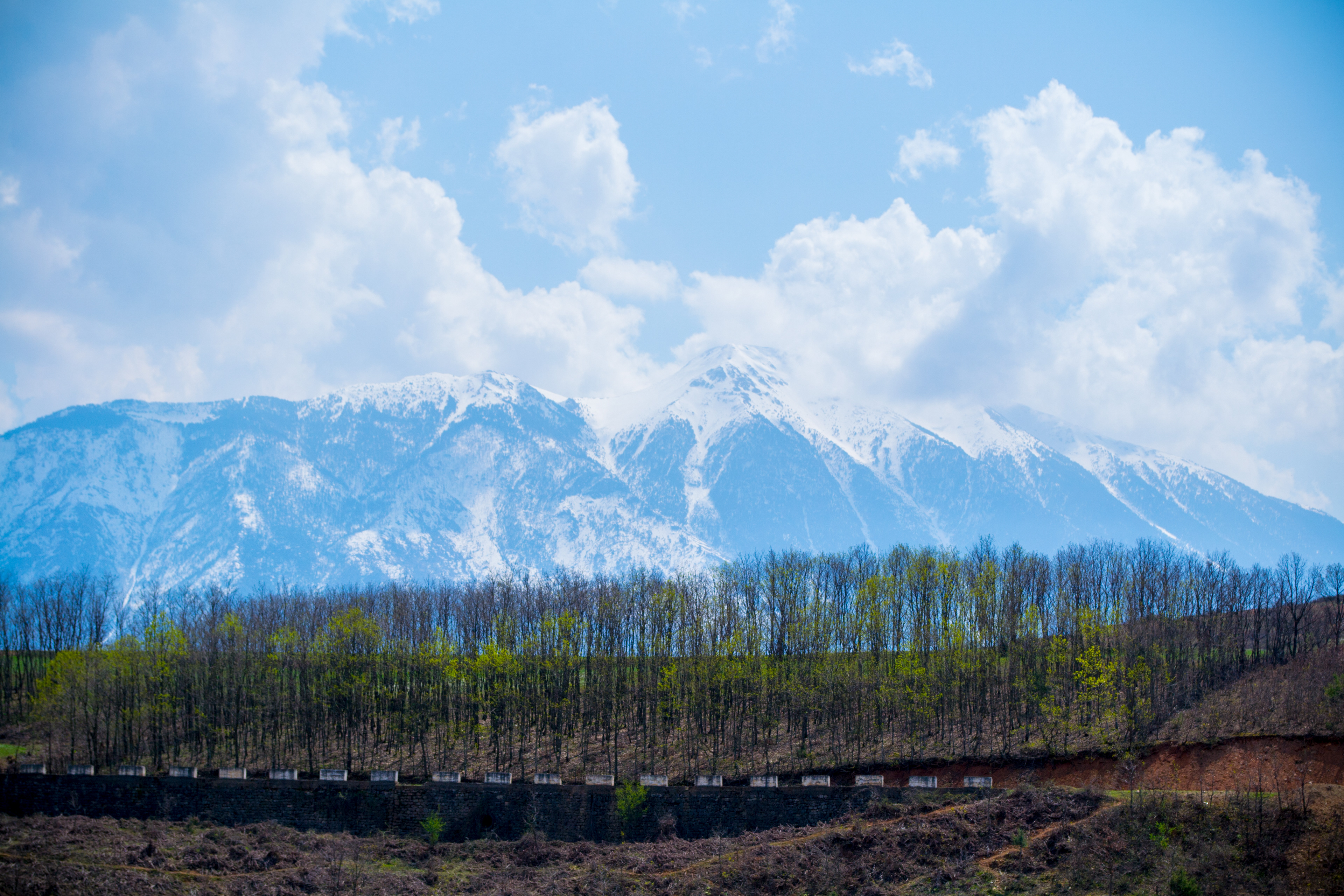 Snowy Balkan Mountains in Albania under Blue Sky with Clouds - Stunning Photo