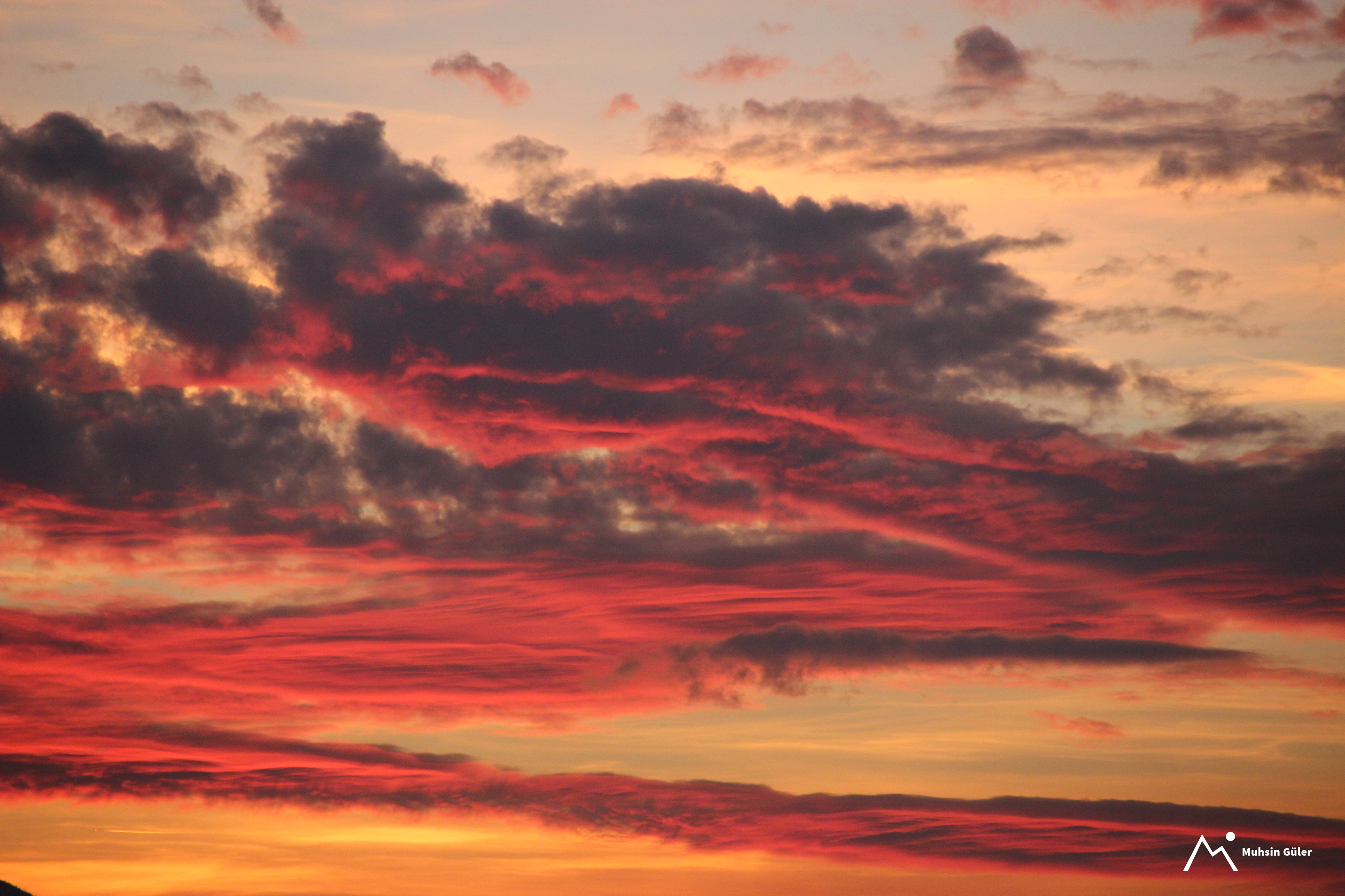 Fiery Skies: A Glowing Sunset with Orange Clouds