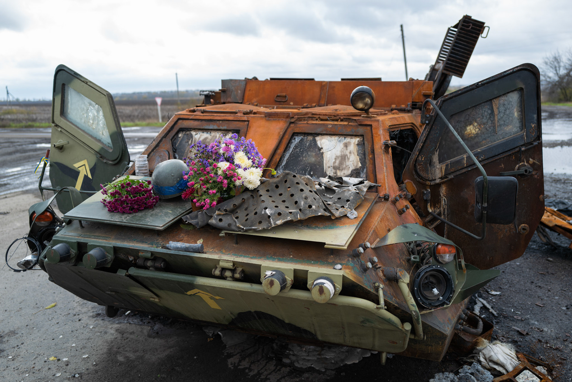DVORICHNA, UKRAINE - October 24: Destroyed Ukrainian troop vehicle with flowers and a helmet to commemorate the fallen.