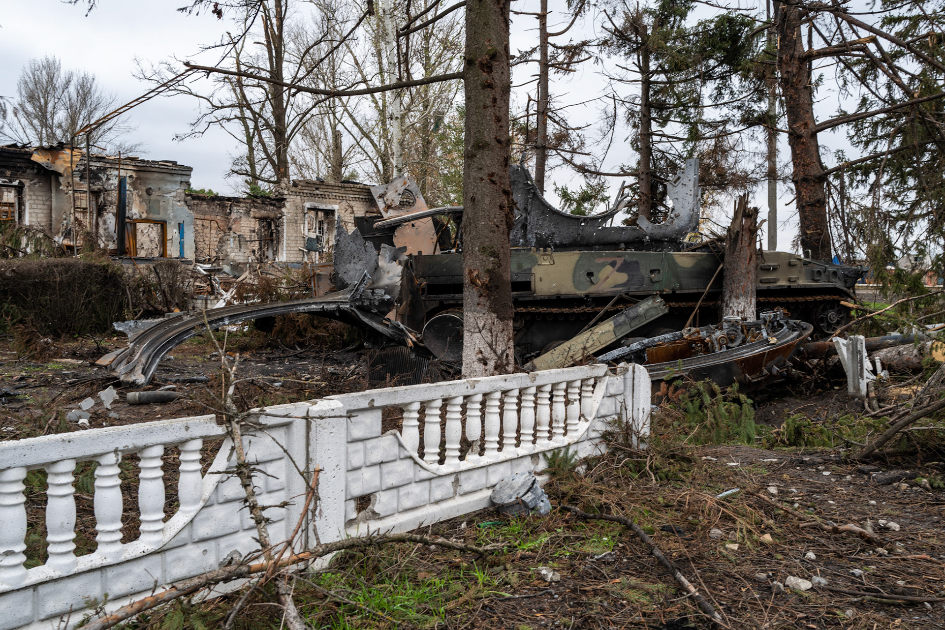 KURYLIVKA, UKRAINE - October 24: White fence in front of a residential building, run over by a tank that was then destroyed.