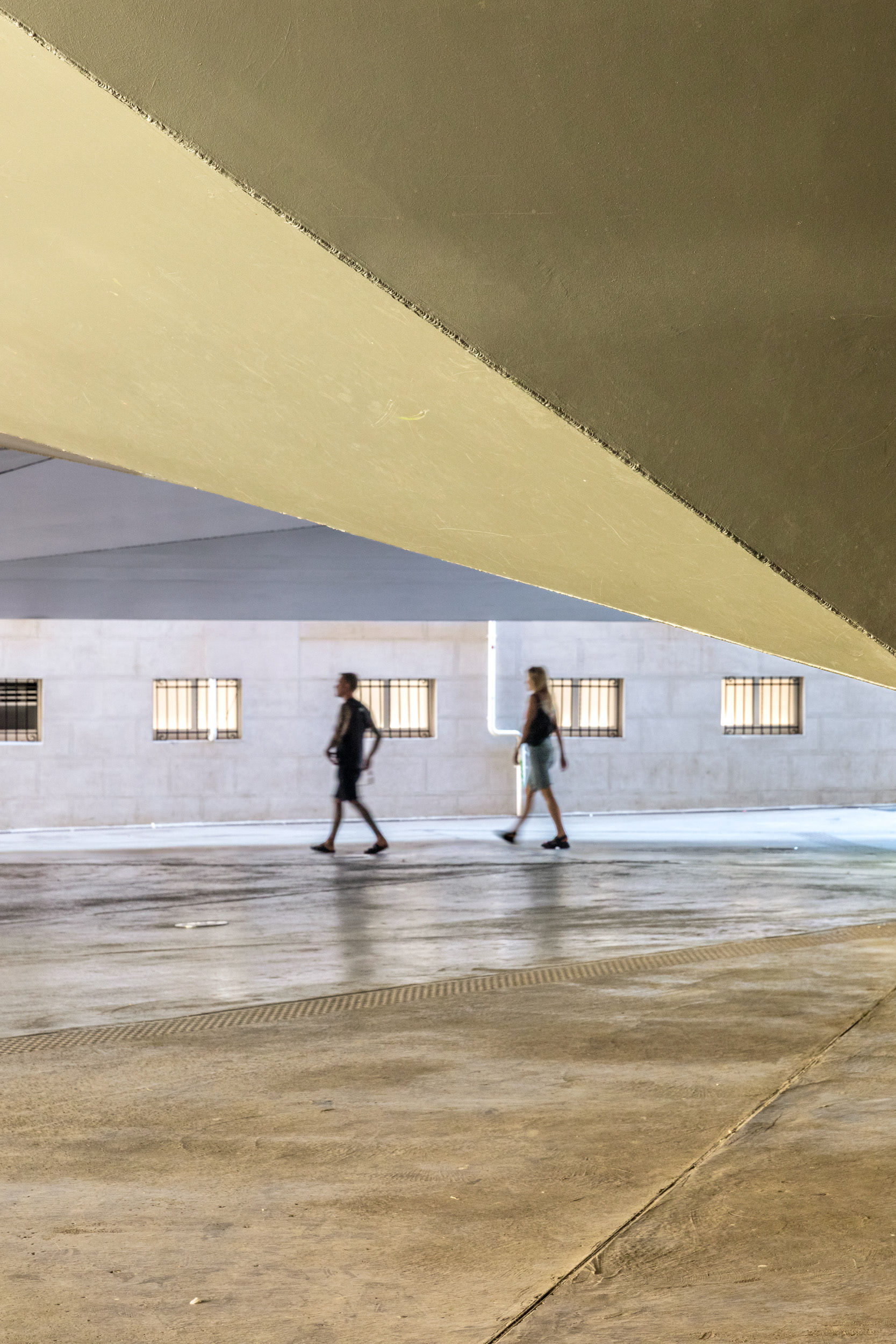 The plaza beneath the lifted brick volume. The building's original granite base was removed to open up this public space.