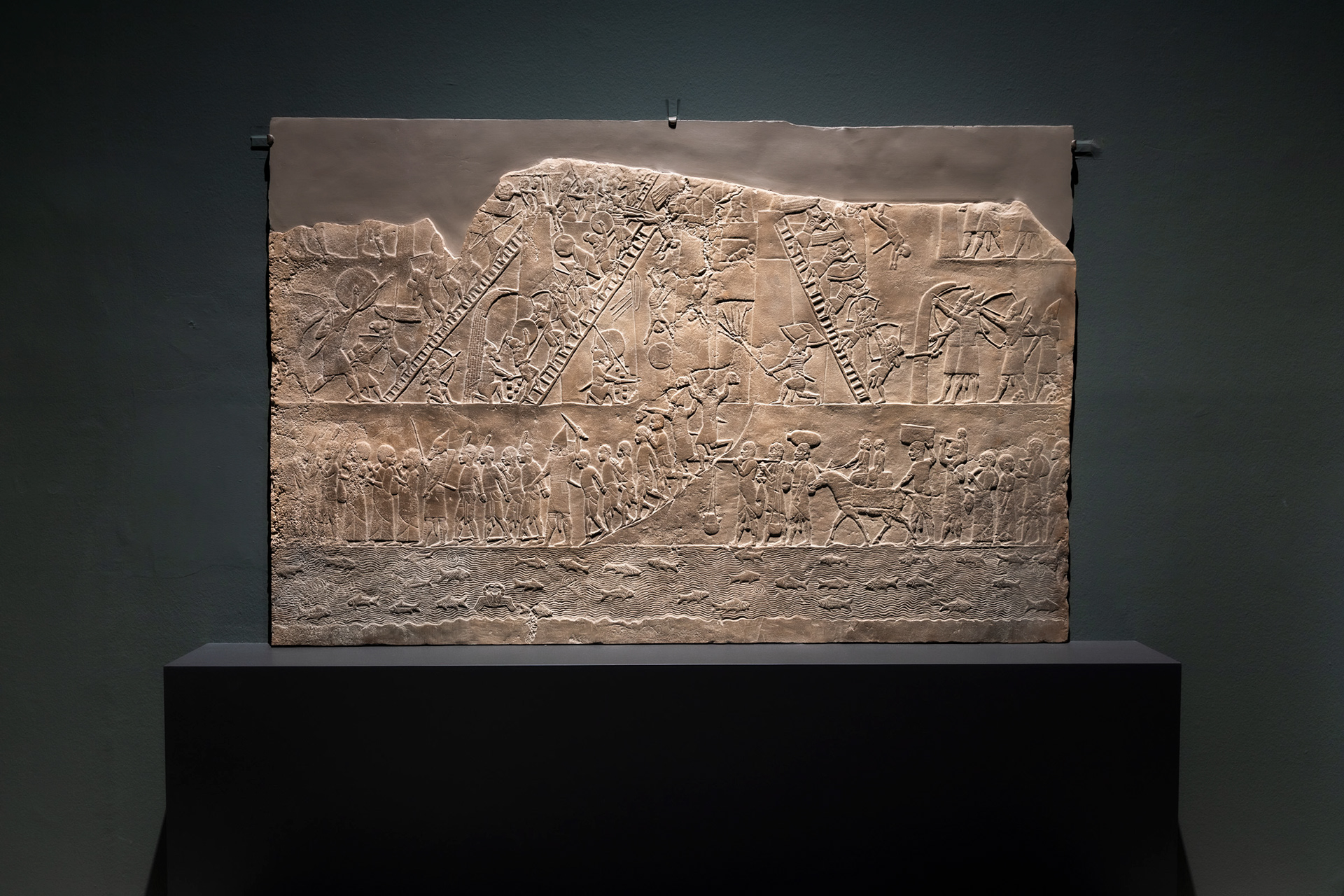 The Egyptian Campaign Relief (c. 645–635 BC) at CaixaForum Madrid. This multi-tiered masterpiece from Nineveh highlights the meticulous detail Neo-Assyrian artists used to record royal conquests and geographic landscapes.