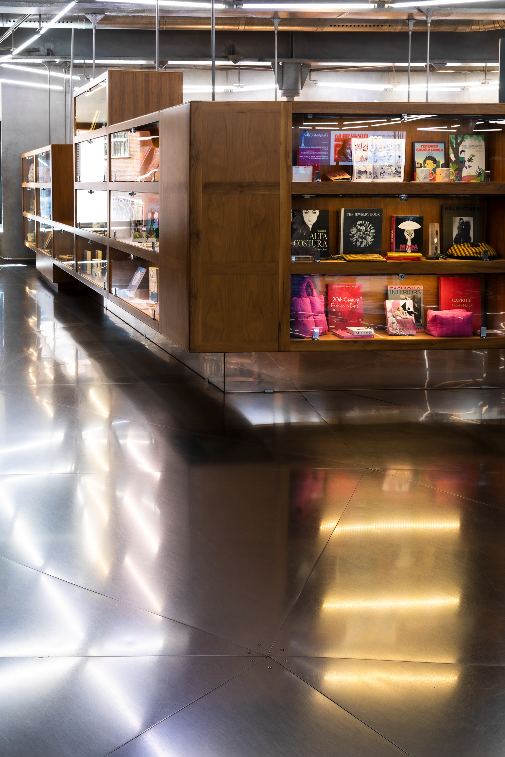 Wood display cases in the CaixaForum bookshop, at lobby level.