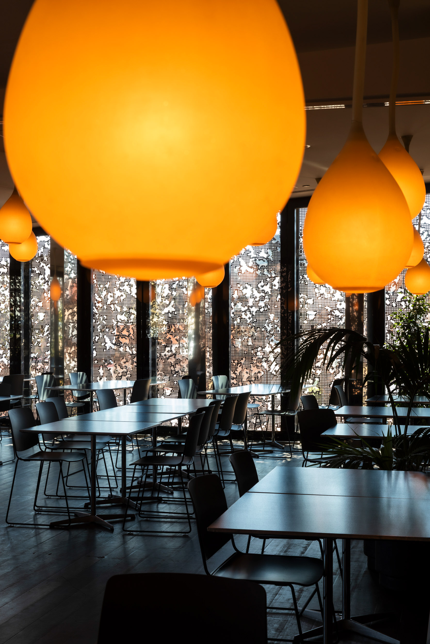 The café on the top floor, inside the building's added upper volume.