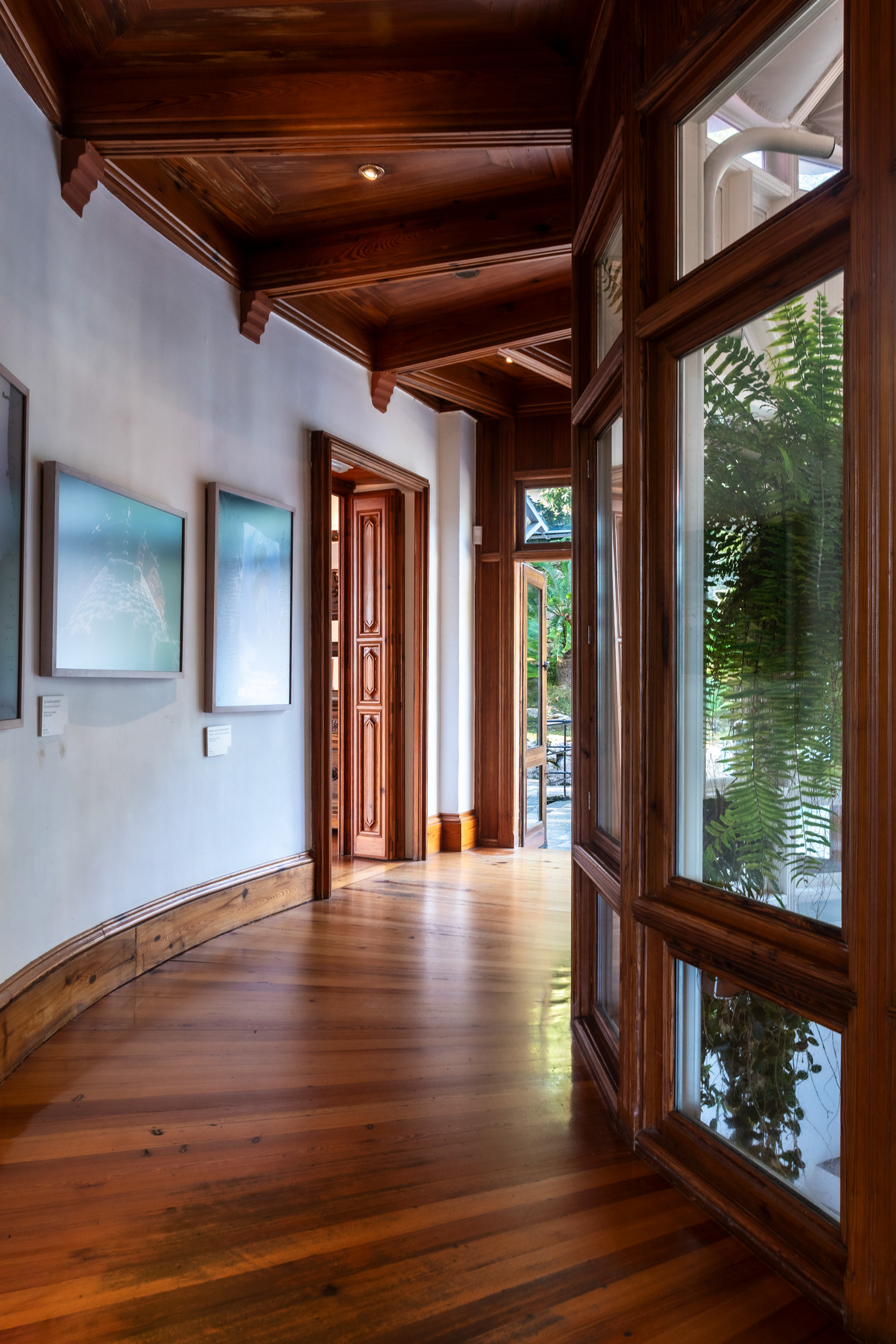 A corridor runs the length of the greenhouse, which sits on the south side and works as the building's thermal buffer.