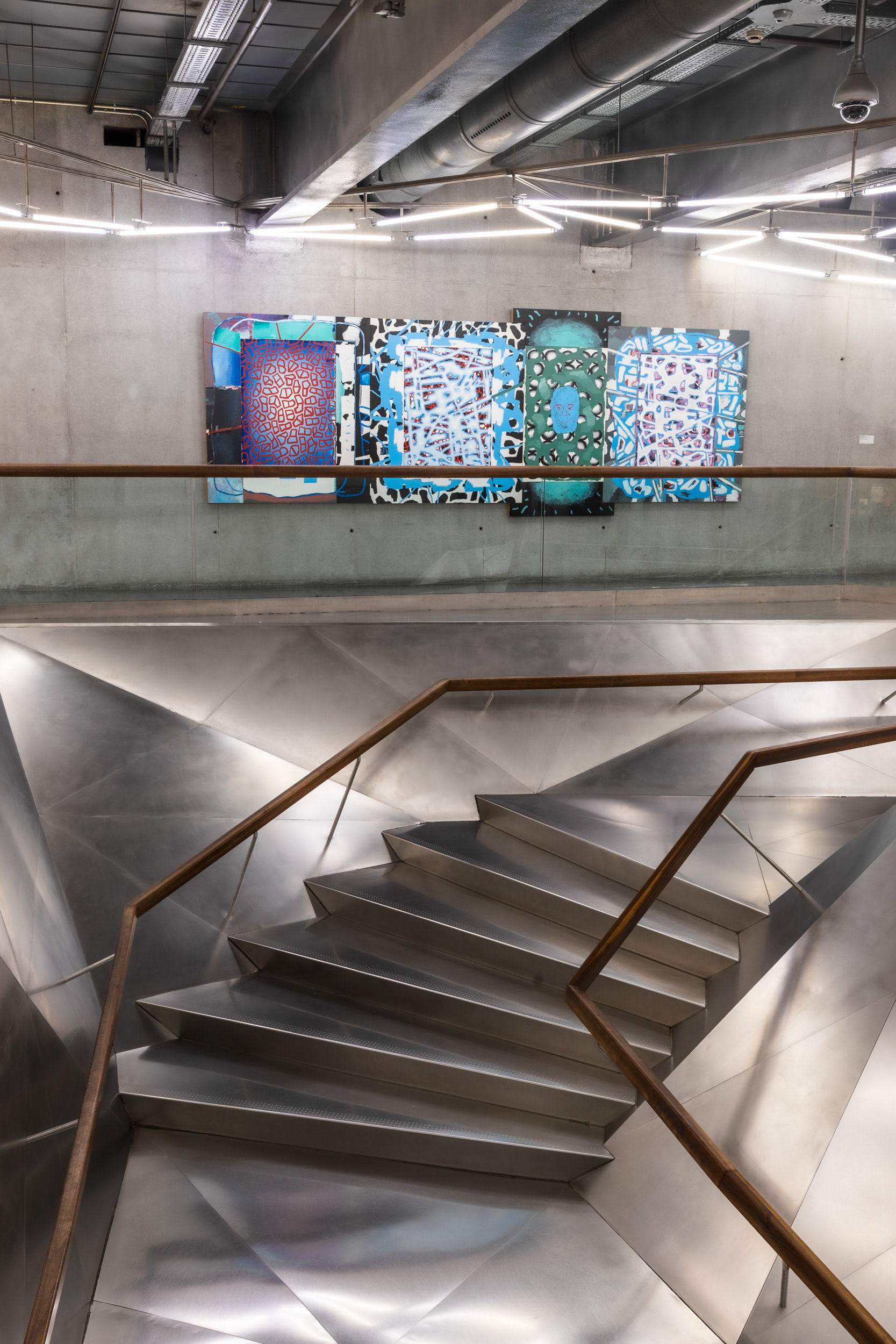 A multi-panel work by the Spanish painter Luis Gordillo, who won the Velázquez Prize in 2007, above the steel staircase.