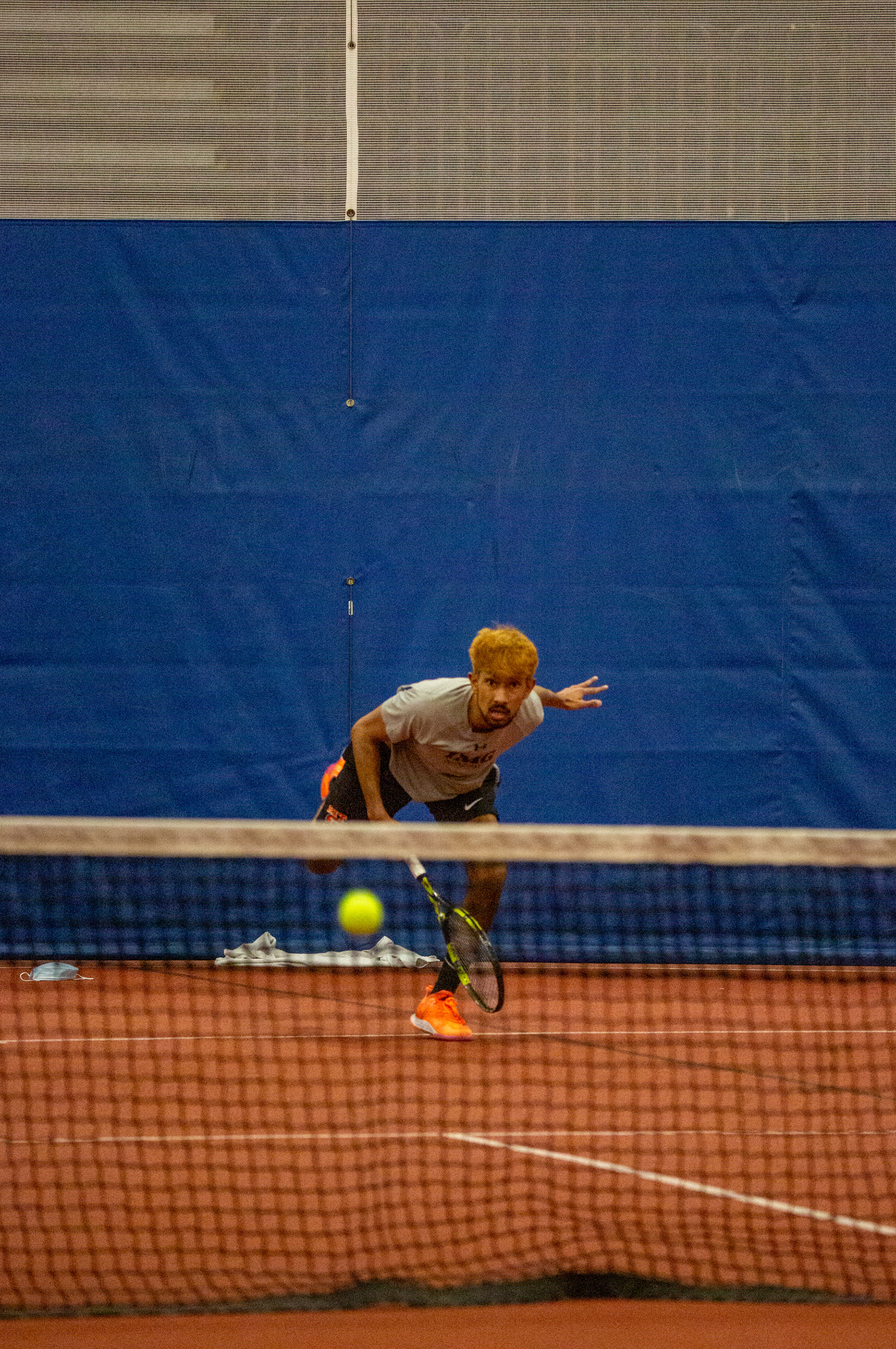 R.I.T. student Verosh Jayanetti hits a tennis ball and watches to make sure it goes over the net at the Gordon Field House at Rochester Institute of Technology on February 27, 2022 in Rochester, N.Y.