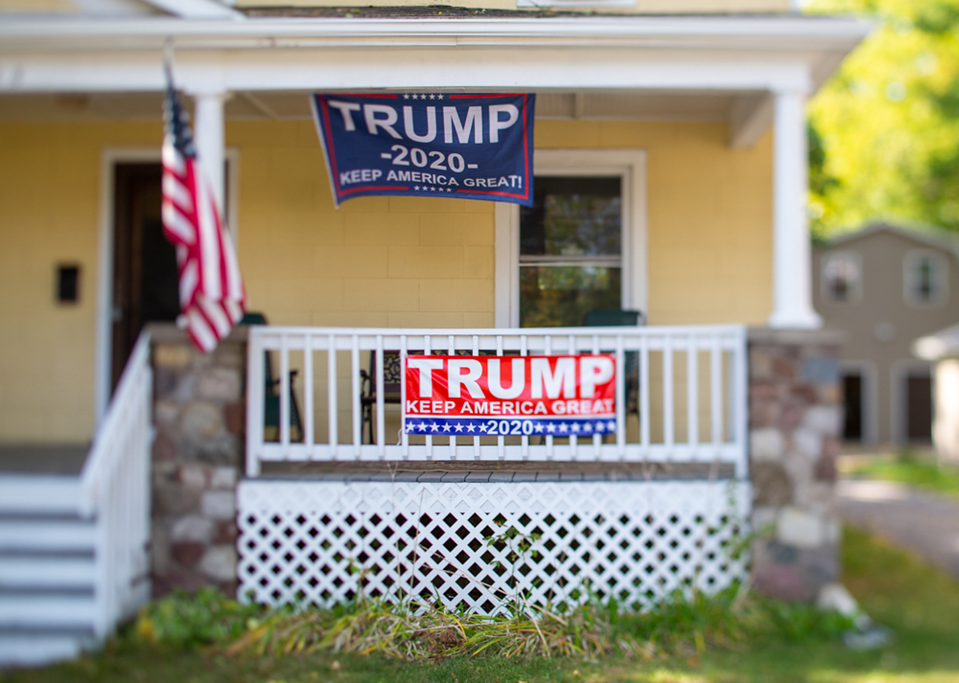 Two Trump signs hang outside of a house on September 27, 2020, Rochester N.Y.
