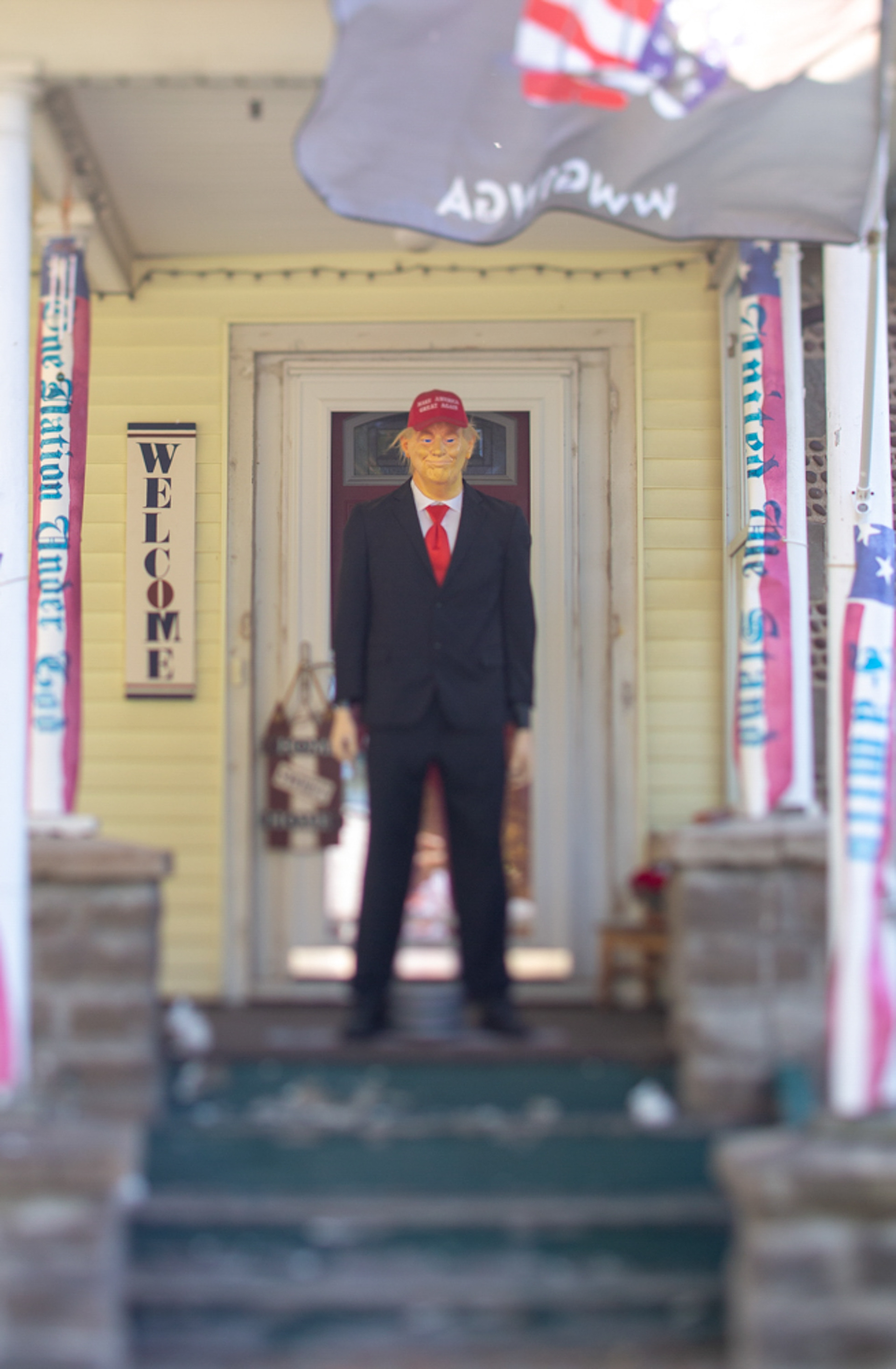 A life-size statue of President Trump stands on a porch, wearing a “Make America Great Again” hat on September 27, 2020, Rochester N.Y.