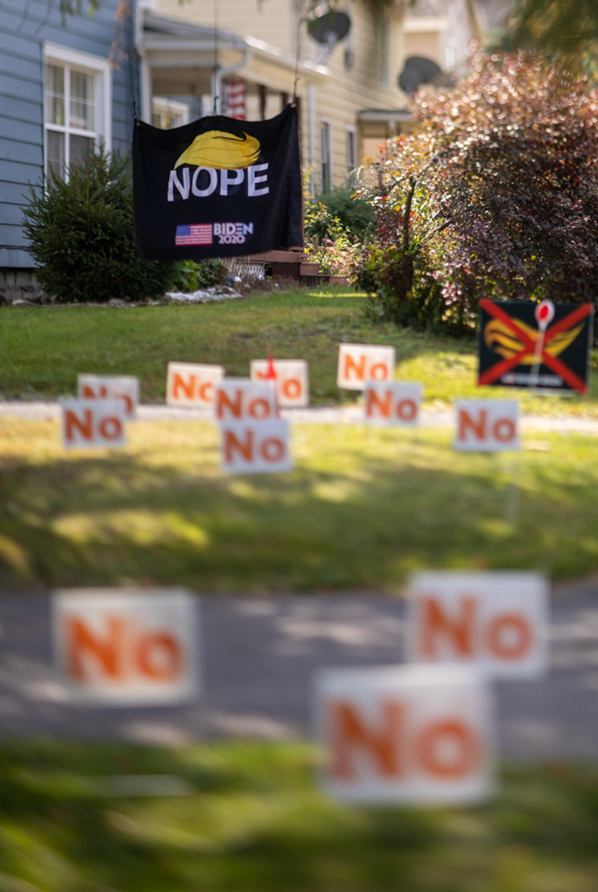 A sign that mocks President Trump’s hair and reads “Nope” on it hangs in the front lawn of a house on September 23, 2020, Auburn N.Y. Under the “Nope” sign, there are also numerous “No” signs placed in the lawn.