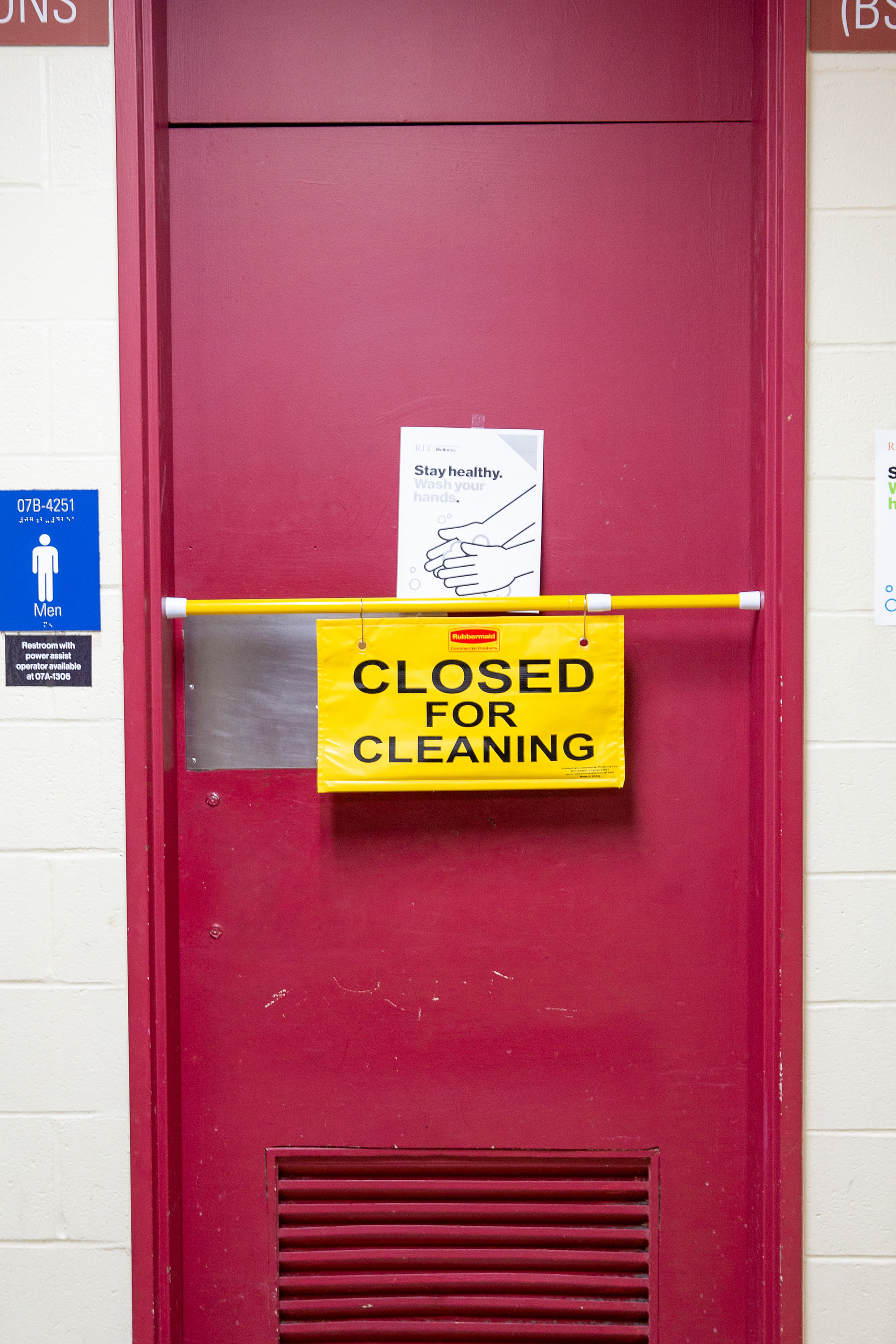 A sign, “Closed for Cleaning”, is displayed on one of the bathrooms on the Rochester Institute of Technology campus on November 11, 2020. In addition to taking extra cleaning precautions, the university is monitoring the number of existing COVID cases on campus through an online dashboard. Through the fall semester there have been a total of 82 cases of the coronavirus, 69 student-related and 13 employee-related cases. The R.I.T. student health center administers COVID-19 tests and throughout the fall semester has tested nearly 10,000 people. Wastewater at R.I.T. is also being monitored. The RIT dashboard states “In addition, RIT implements an early surveillance program that includes wastewater testing twice a week. To date, these samples cover nearly 6,500 individuals.”