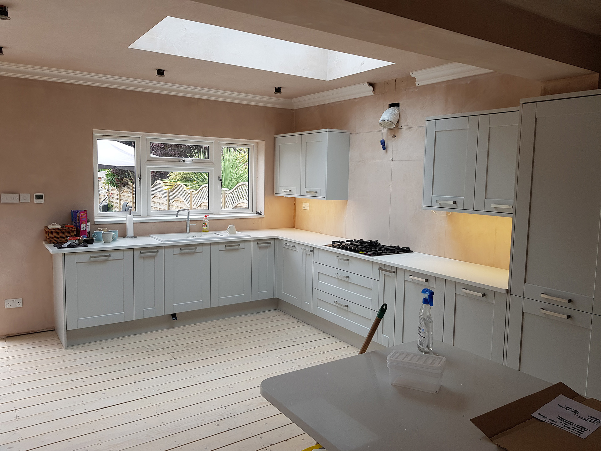 Kitchen installed, featuring one of two skylights.