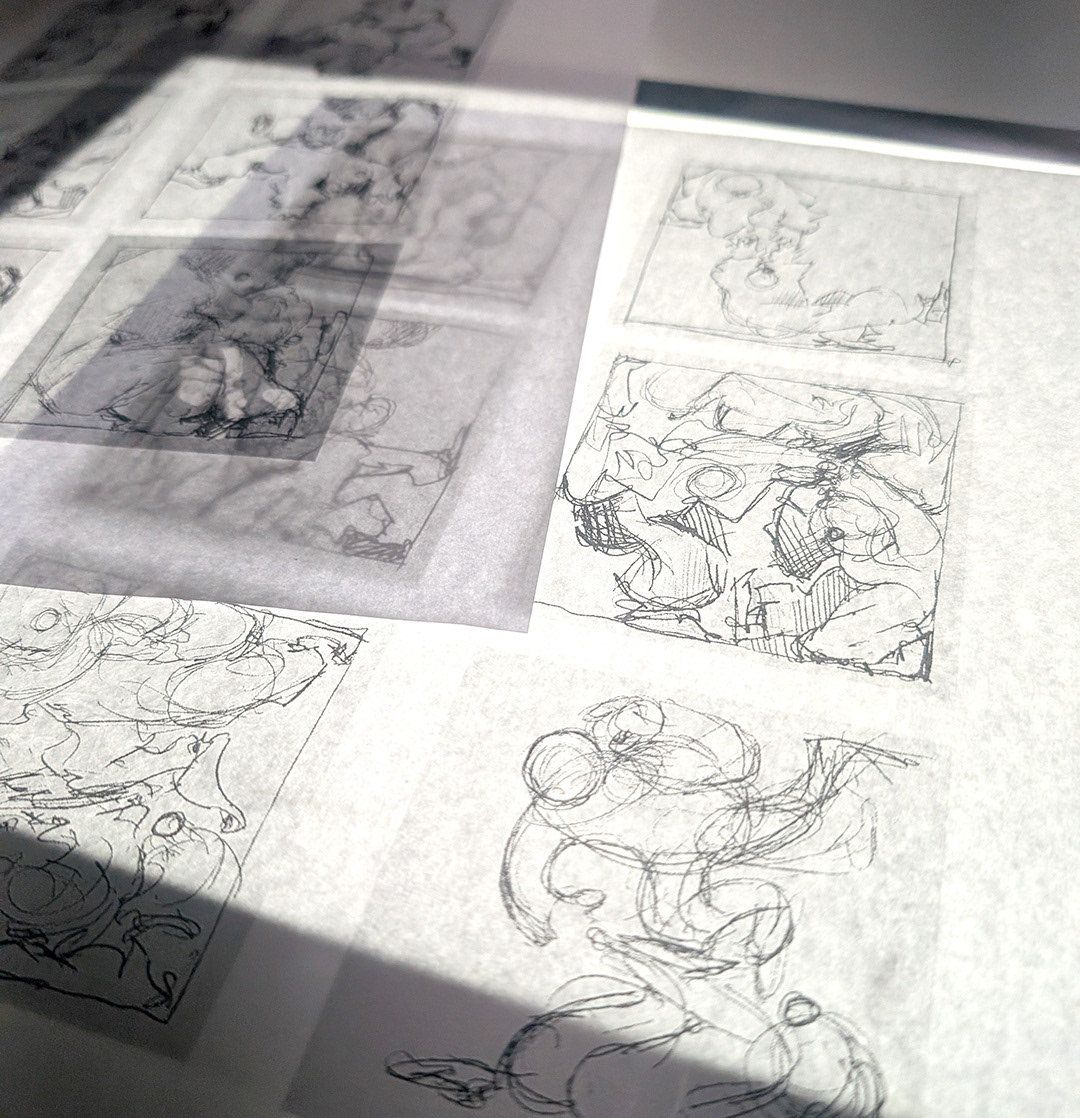 A photo of the base figure sketches on a light-box. 