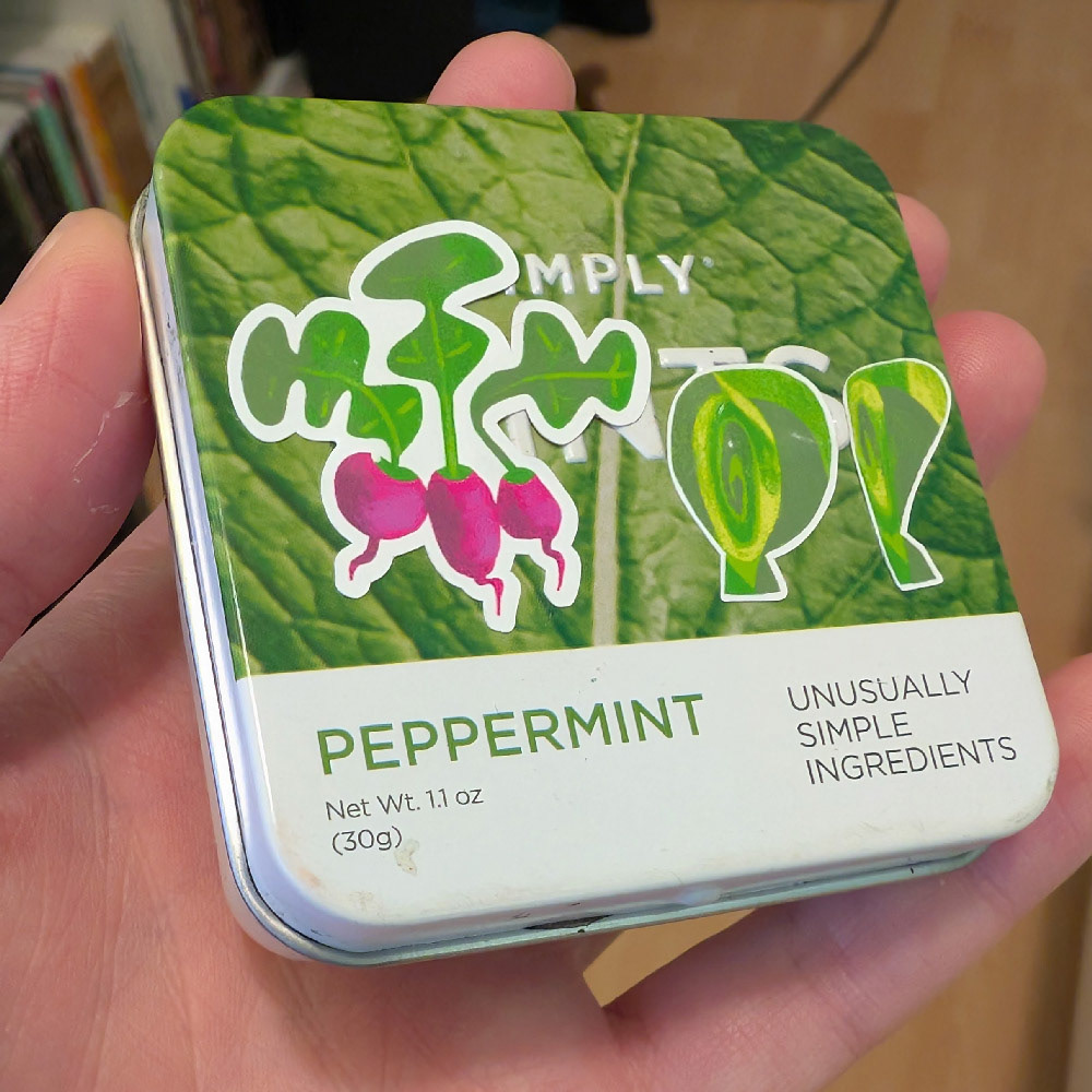 my mint-tin watercolour palette, closed. It features stickers of radishes brussel sprouts, from my kitchen objects sticker sheet.