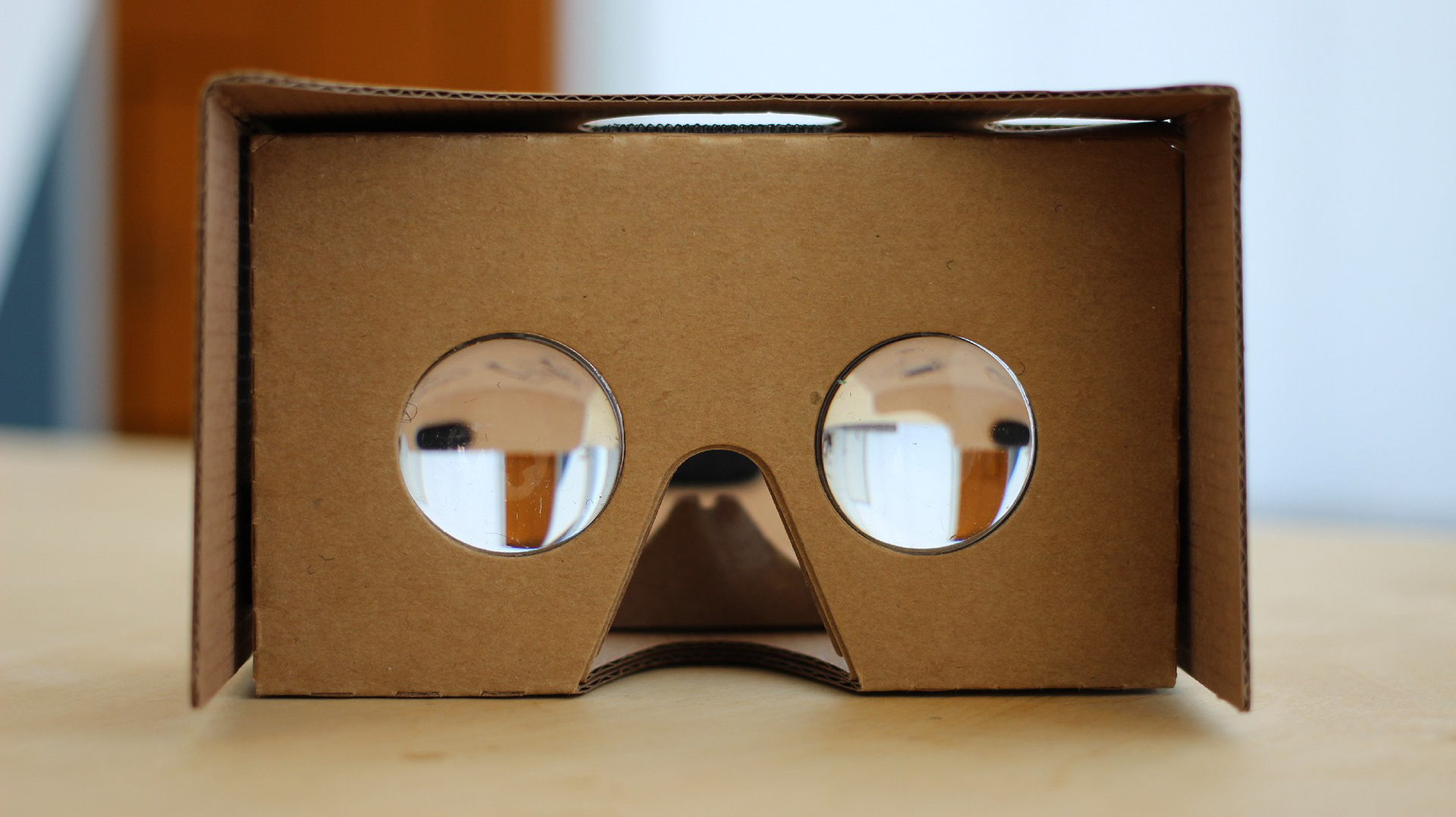 Google Cardboard opened, with the camera looking through it's lenses.