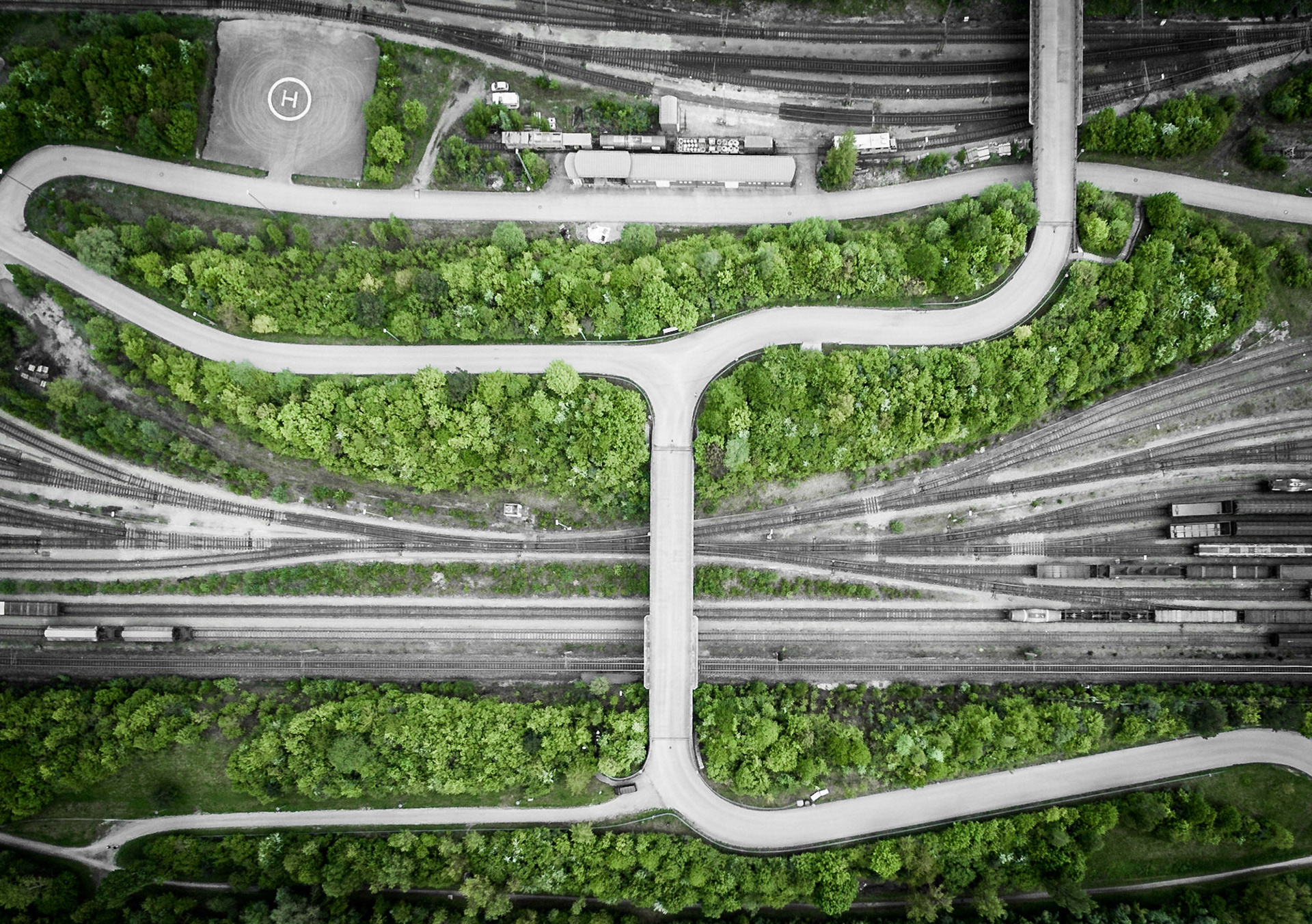 Aerial photo of railway tracks and a street in the shape of the letter H. Germany, Munich, 2015
