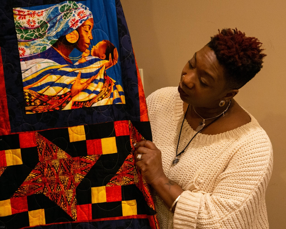 Kellman shares the story behind a quilt gifted to her by a licensed Virginia CPM, in Ferguson, Mo., Monday, Nov. 4, 2019. “Due to racism and oppression in midwifery in Missouri, I had to travel [to Virginia] to complete my work in an apprenticeship that wasn’t racist,” she said.