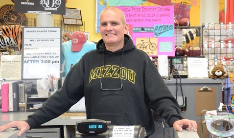 Steve Dillard stands at the counter of his store Tiger Spirit on Tuesday, April 3, 2018 in Columbia, Mo. Dillard has owned the shop with his wife, Michelle, for 19 years; they collected merchandise from 50-75 companies to sell.