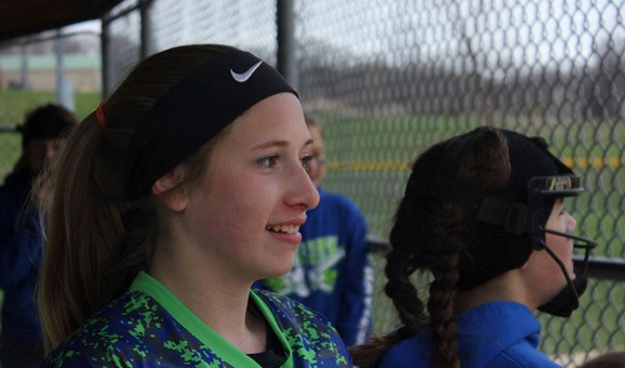 Elysia Hand, 13, looks out onto the field from her team’s dugout on Saturday, April 14, 2018 in Blue Springs, Mo at Hidden Valley Softball Complex. Hand can usually be found at the fence cheering on her teammates.