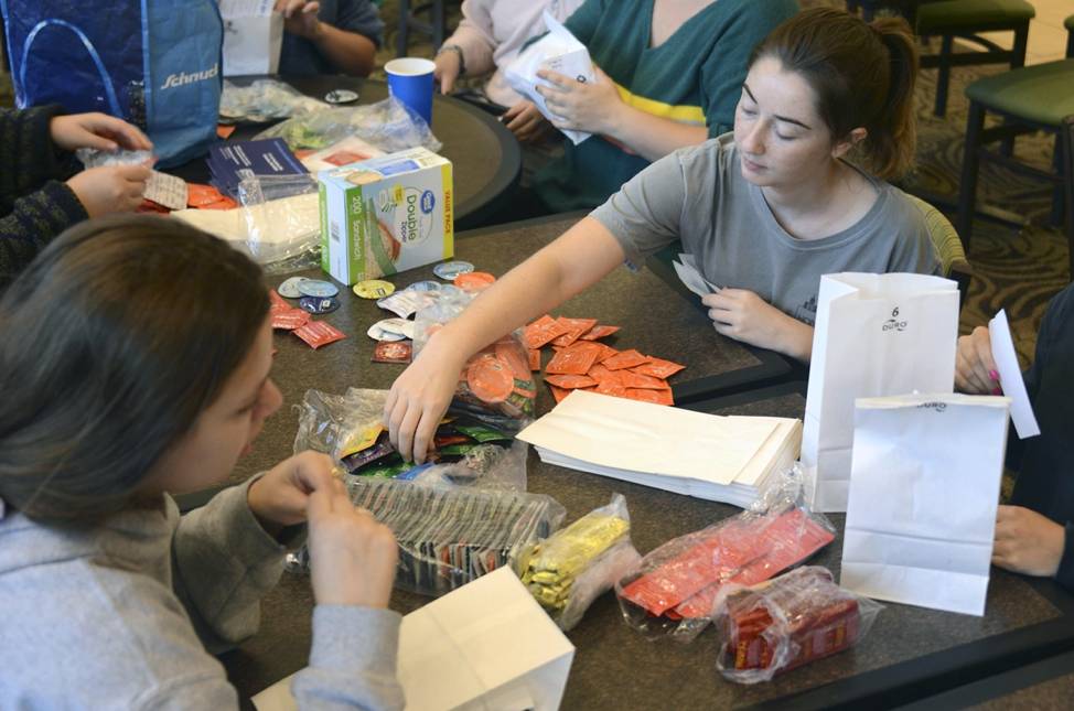 Claire Hornibrook adds condoms to a safe sex kit at the MU Student Center in Columbia, Mo., on Thursday, Oct. 10, 2019. Hornibrook is a member of the Planned Parenthood Advocates of Mizzou. The safe sex kits include three condoms, a flyer about the local Planned Parenthood and another flyer about consent.