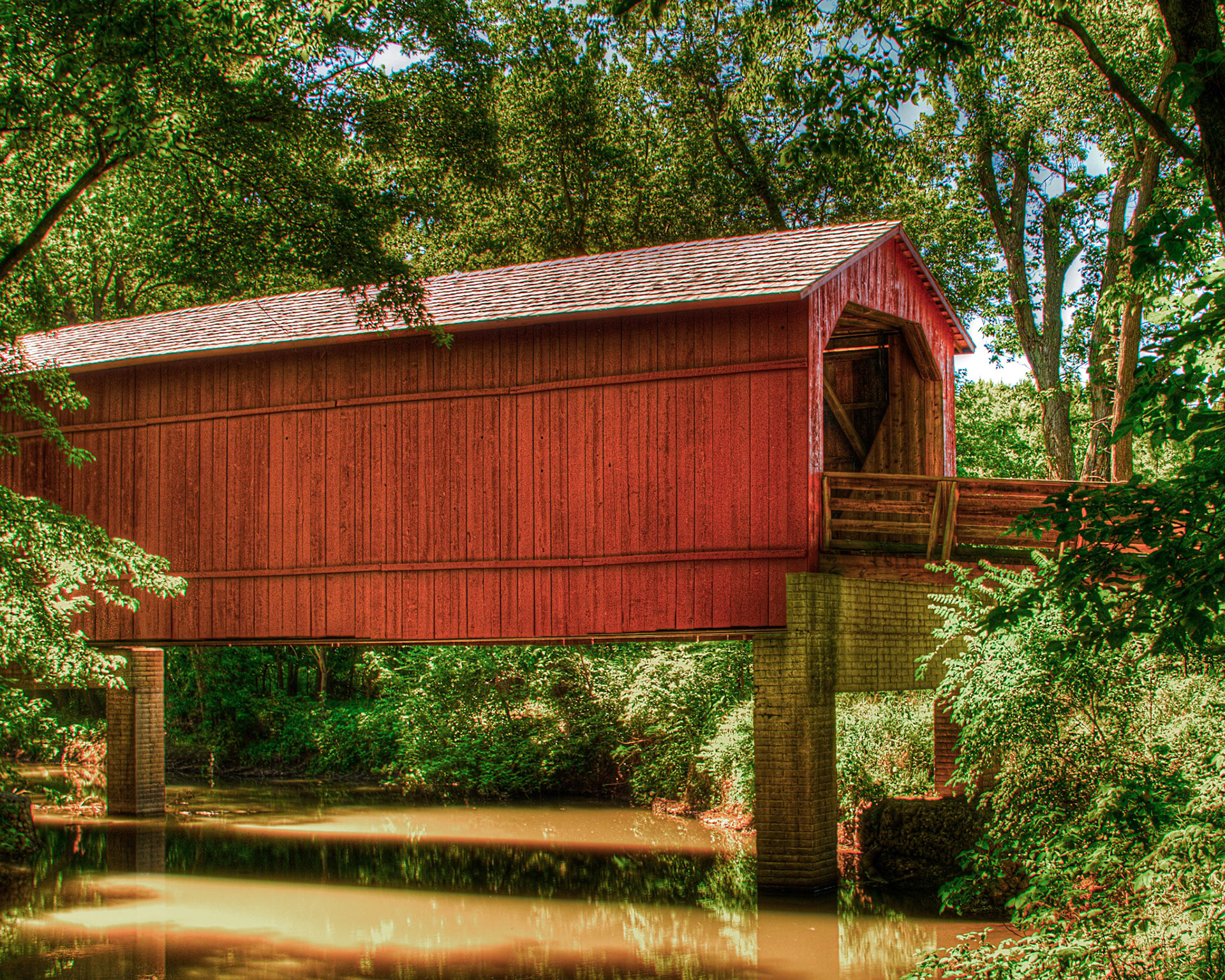 The Covered Bridge on Sugar Creek, also known as the Glenarm or the Hedley Bridge, was originally constructed in 1880 using the Burr Arch design and was rehabilitated in 1969 by IDOT. The bridge can be found by exiting at Glenarm (exit 83) off of I-55, just west of Springfield, IL.