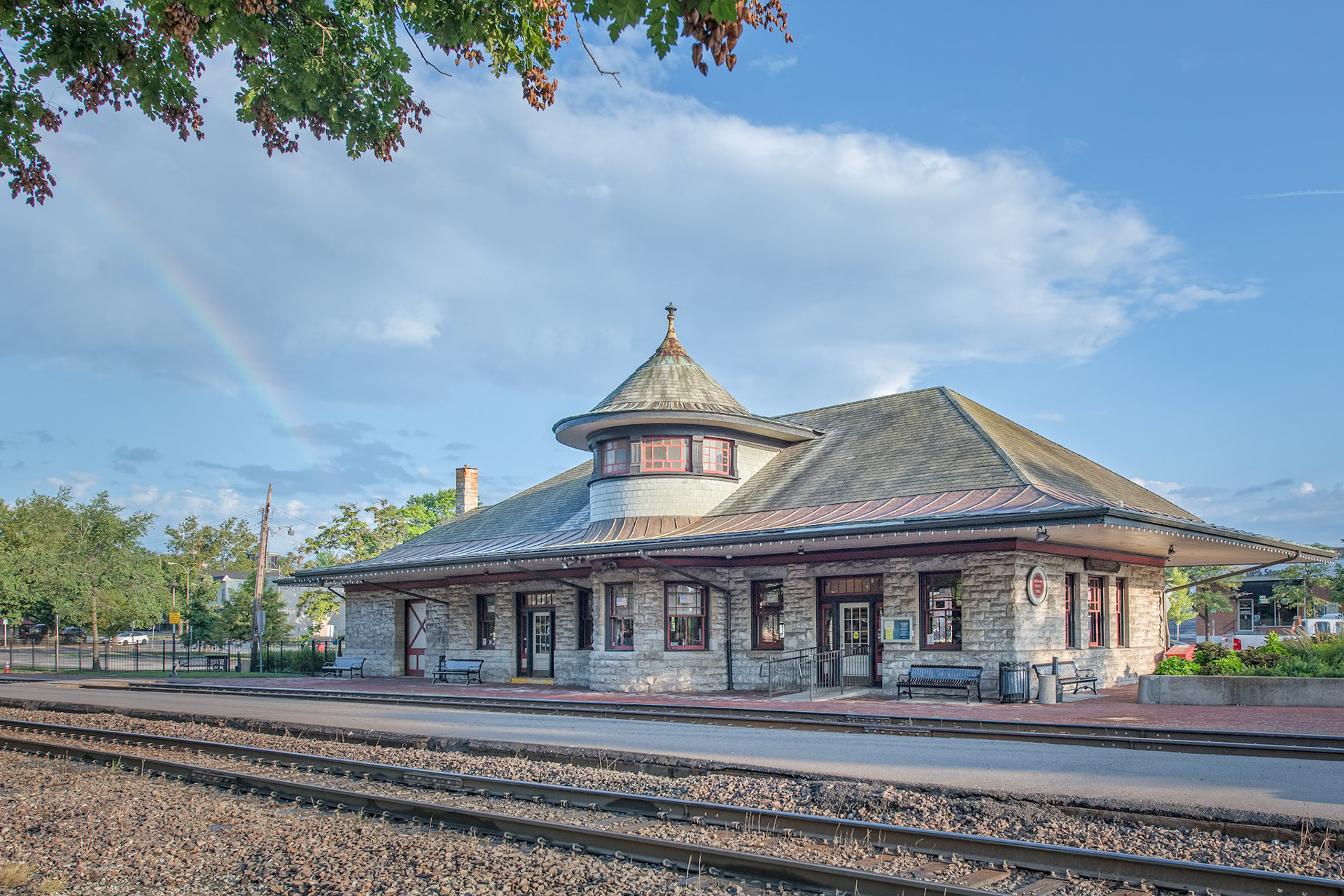 The Kirkwood Train Station is an example of Richardsonian architecture and was constructed by Douglass Donovan to replace a previous wooden station. The track for the Pacific Railroad to Kirkwood was completed in 1853. The first train arrived May 11, 1853, for an auction sale of lots, making Kirkwood the first planned suburb west of the Mississippi. The town was named for the chief engineer for the railroad, James P. Kirkwood. Commuter trains ran to and through Kirkwood until 1961. It is still an active station for Amtrak service and also serves as a visitors center.