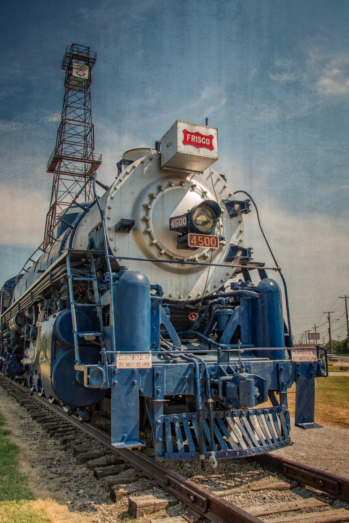 Route 66 Historical Village is an attraction along Old Route 66 in Tulsa, Oklahoma. When visiting in August, 2015, it displayed a restored Frisco 4500 Steam Engine and other restored rail cars, as well as a centennial oil derrick and historic pump jack.