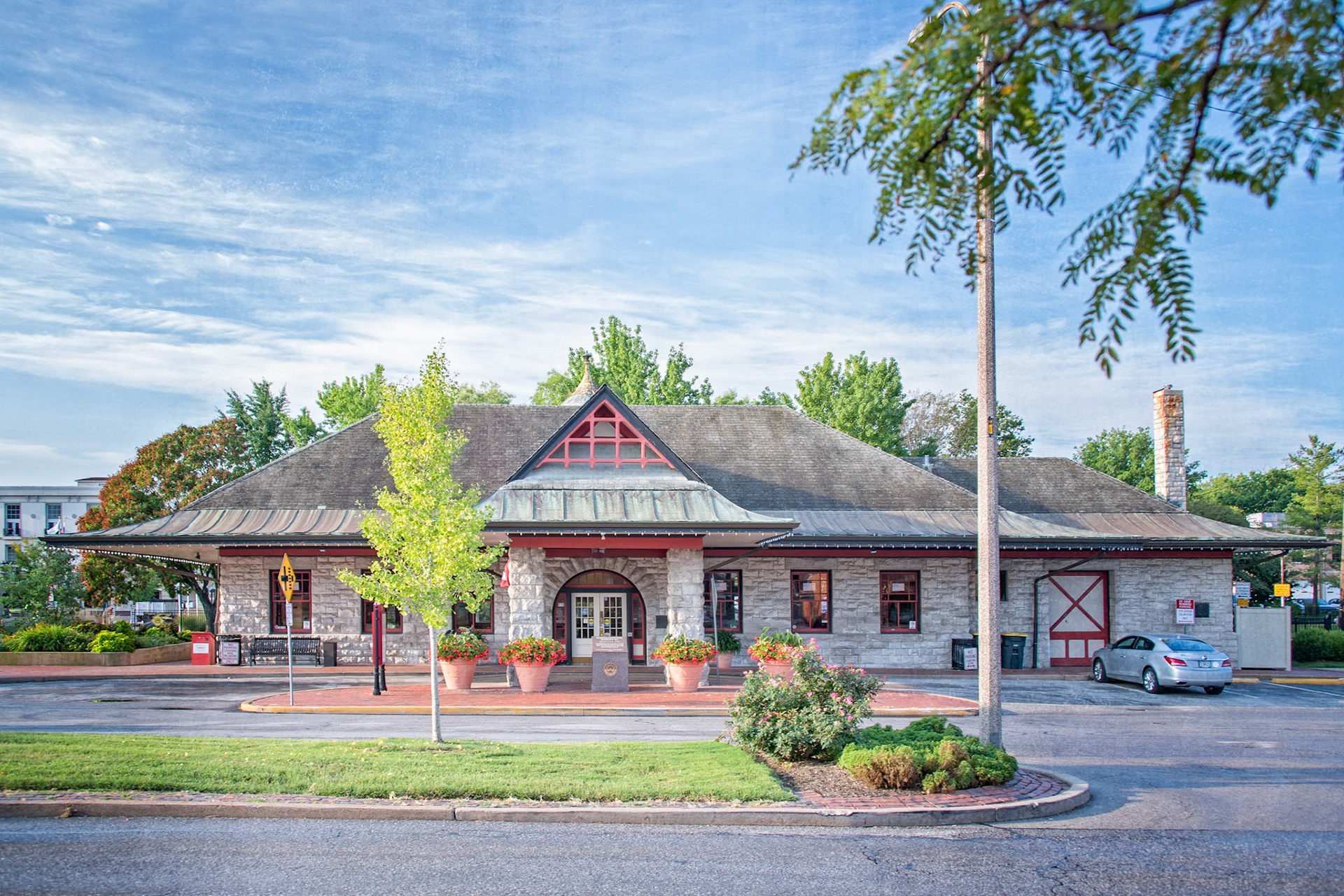 The Kirkwood Train Station is an example of Richardsonian architecture and was constructed by Douglass Donovan to replace a previous wooden station. The track for the Pacific Railroad to Kirkwood was completed in 1853. The first train arrived May 11, 1853, for an auction sale of lots, making Kirkwood the first planned suburb west of the Mississippi. The town was named for the chief engineer for the railroad, James P. Kirkwood. Commuter trains ran to and through Kirkwood until 1961. It is still an active station for Amtrak service and also serves as a visitors center.