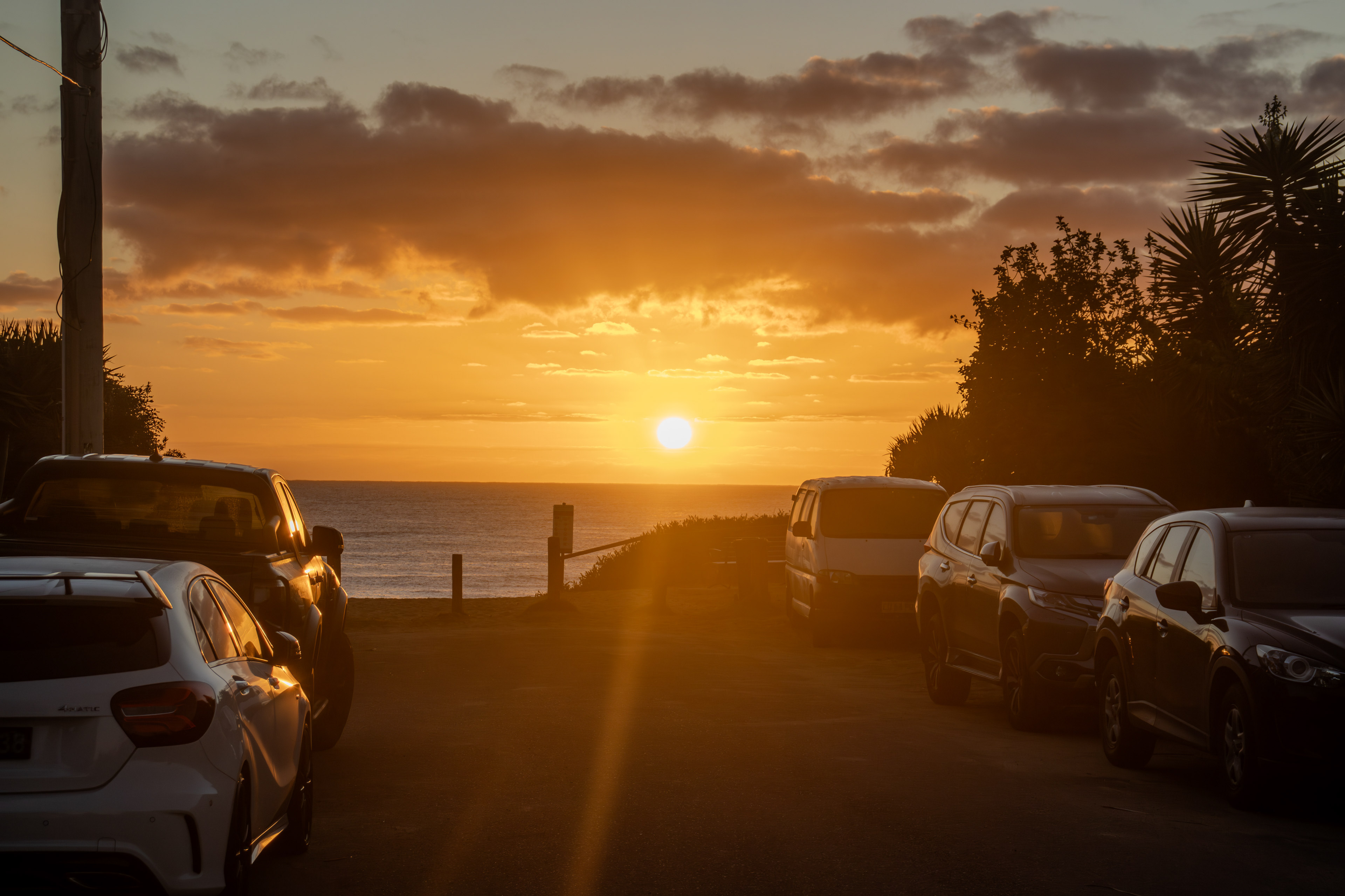Sunrise along a street adjacent to the beach