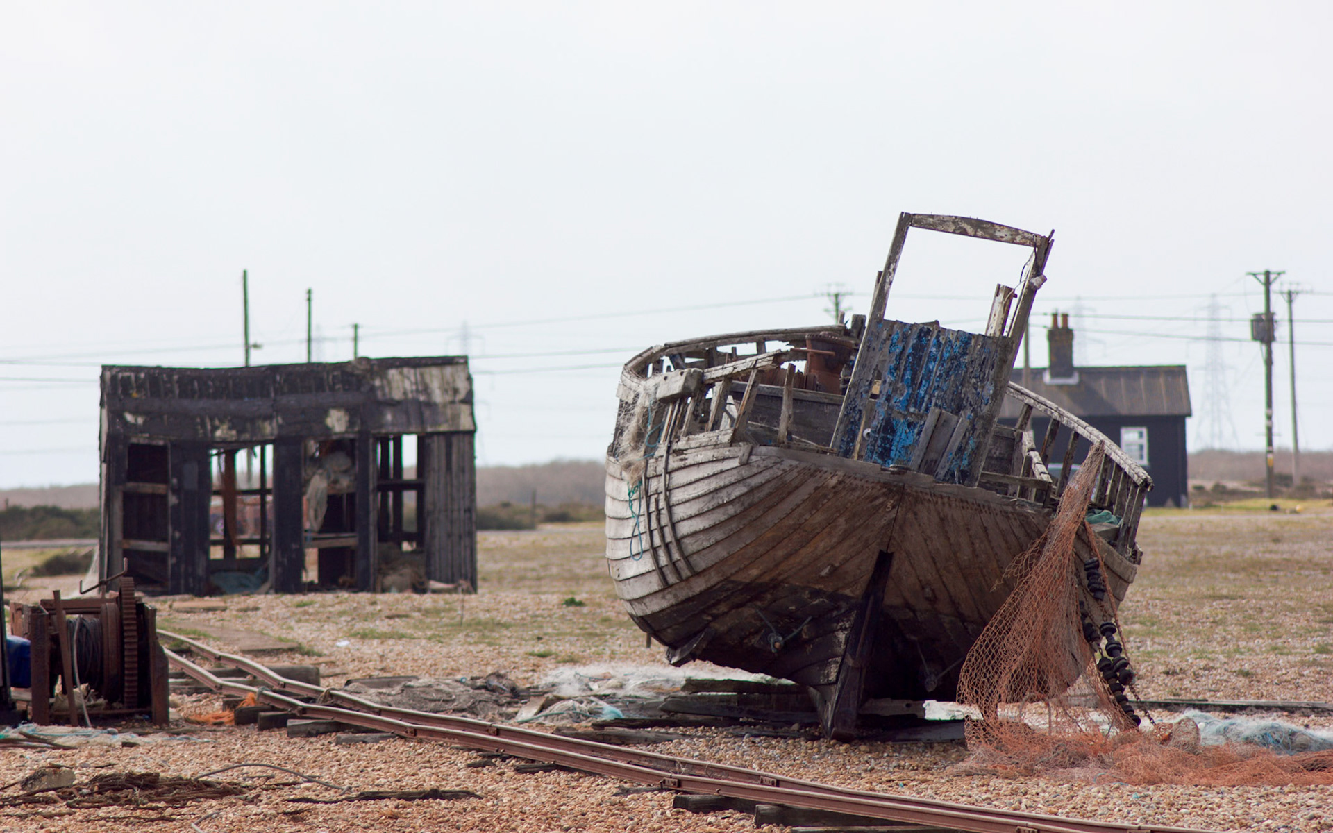 An abandoned fishing boat next to the railway tracks in Dungeness