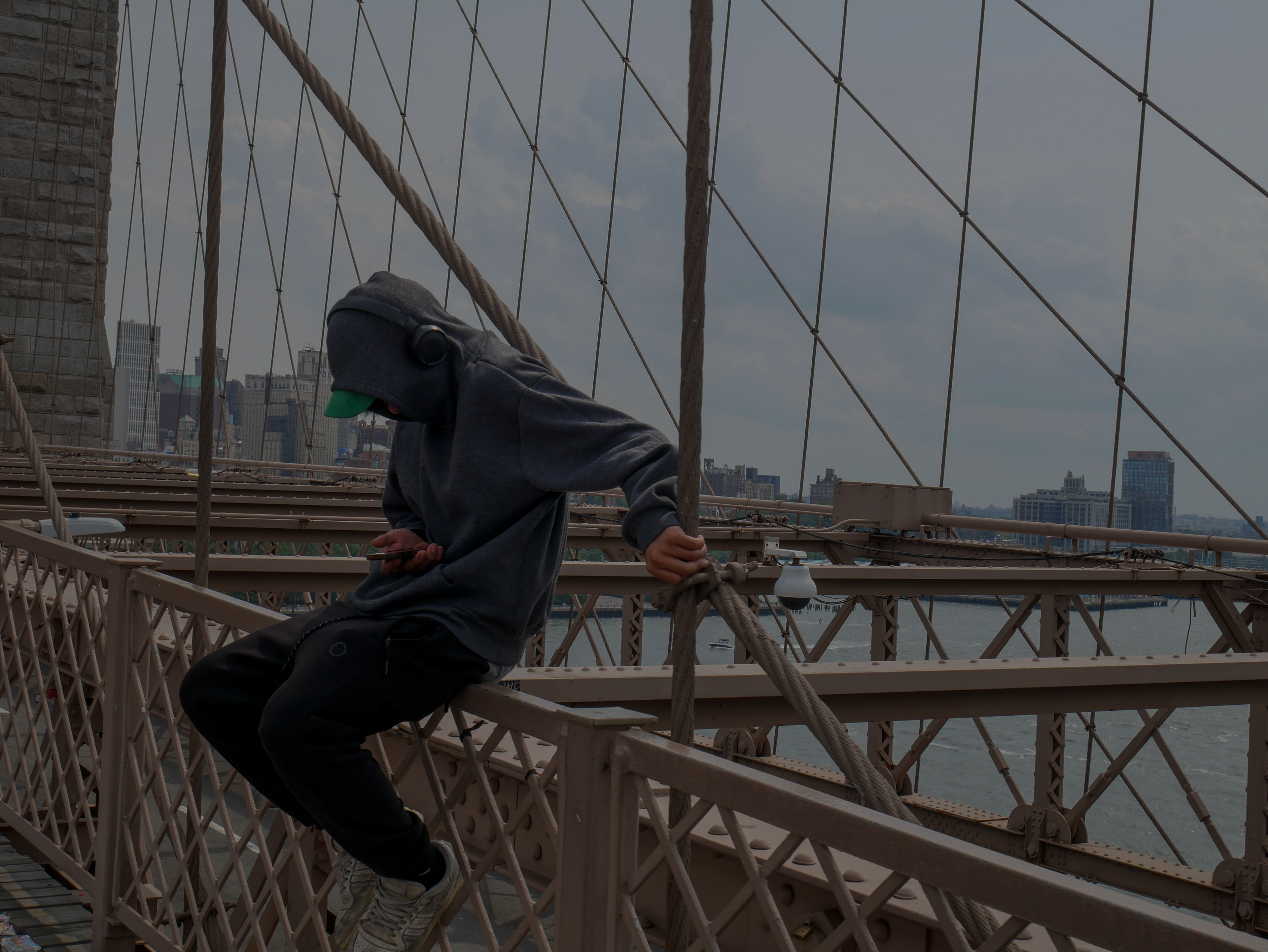 I can see a man sitting on the bridge.