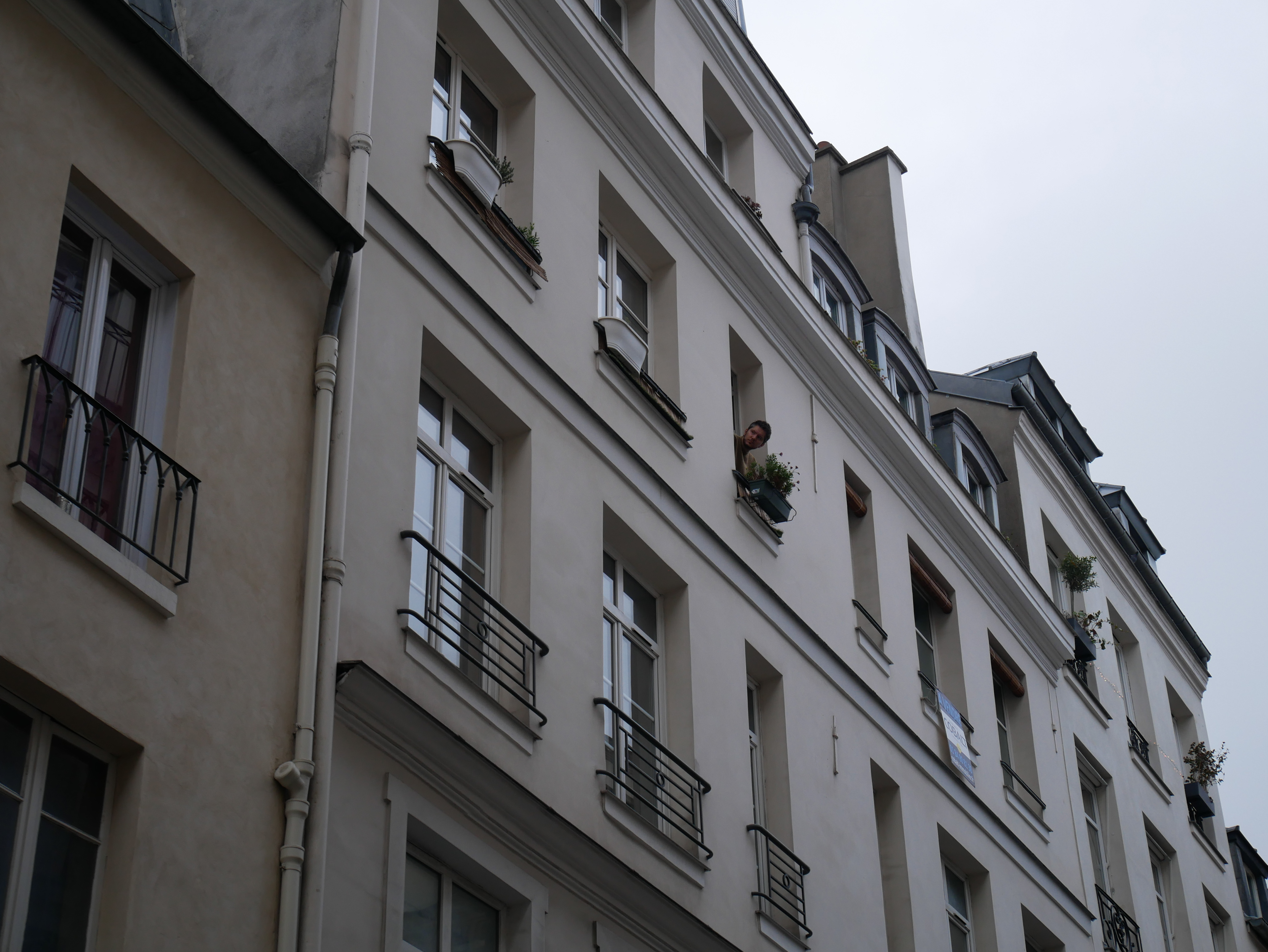 I can see a man in the window.