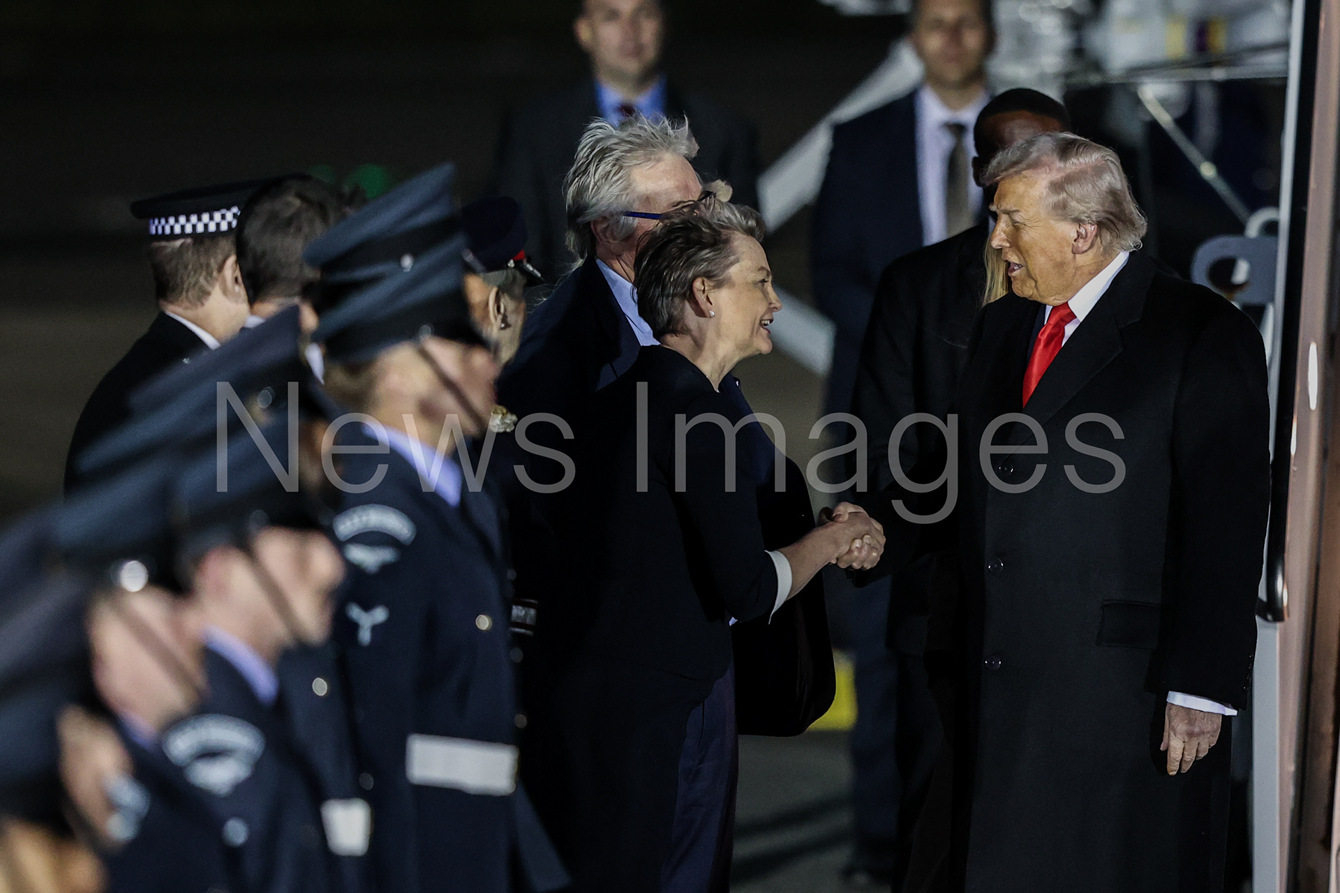 US President Donald Trump shakes hands with Foreign Secretary Yvette Cooper as he lands in the UK for his second State Visit