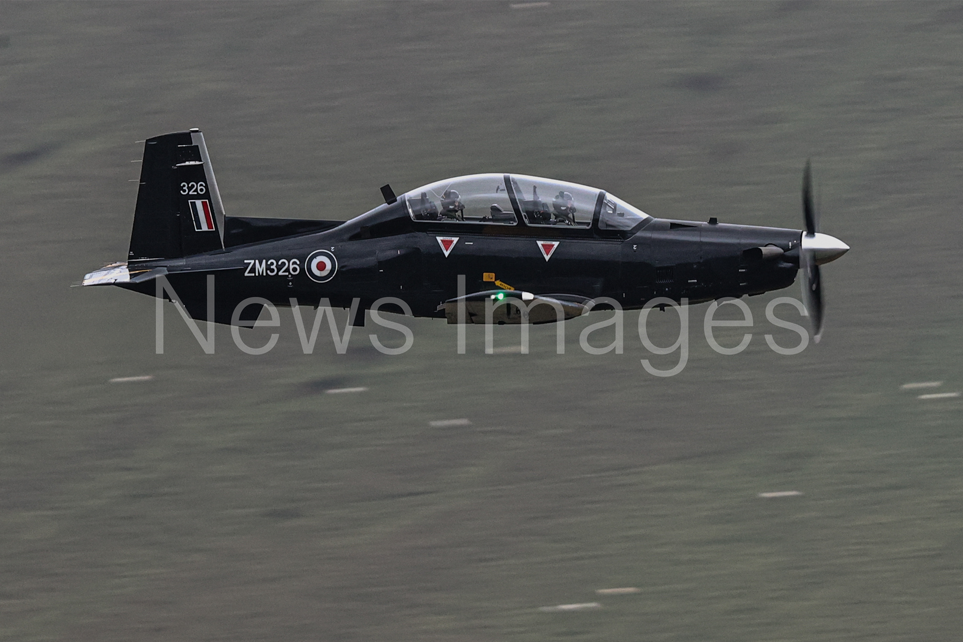 A Texan T1 flies low level through Mach Loop