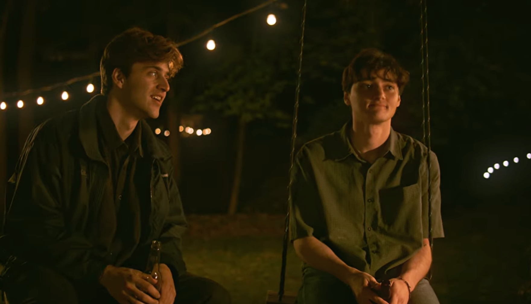 Two men sitting on swings Still from LOVEBITES film