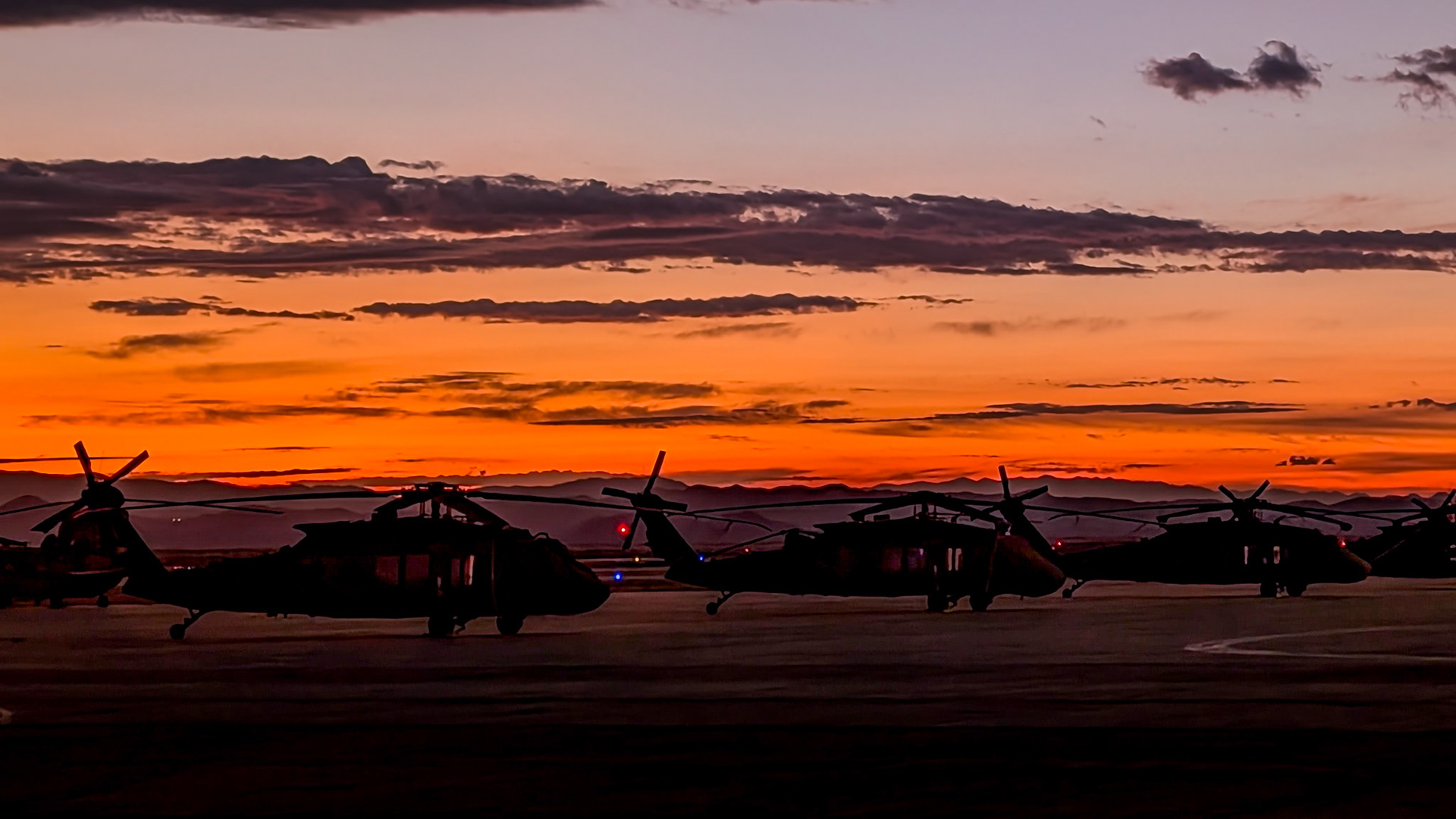 Blackhawk helicopters at sunset