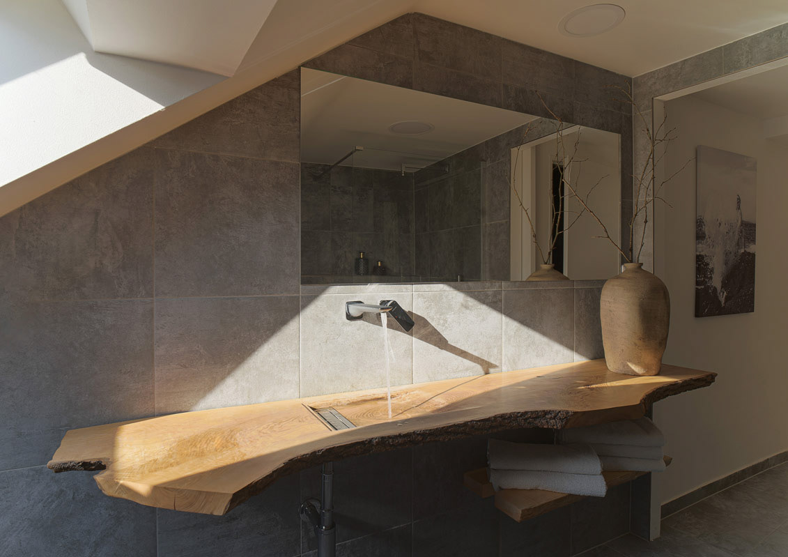 Author-designed solid wood washbasin in a minimalist bathroom interior, Perdok & Novotná.